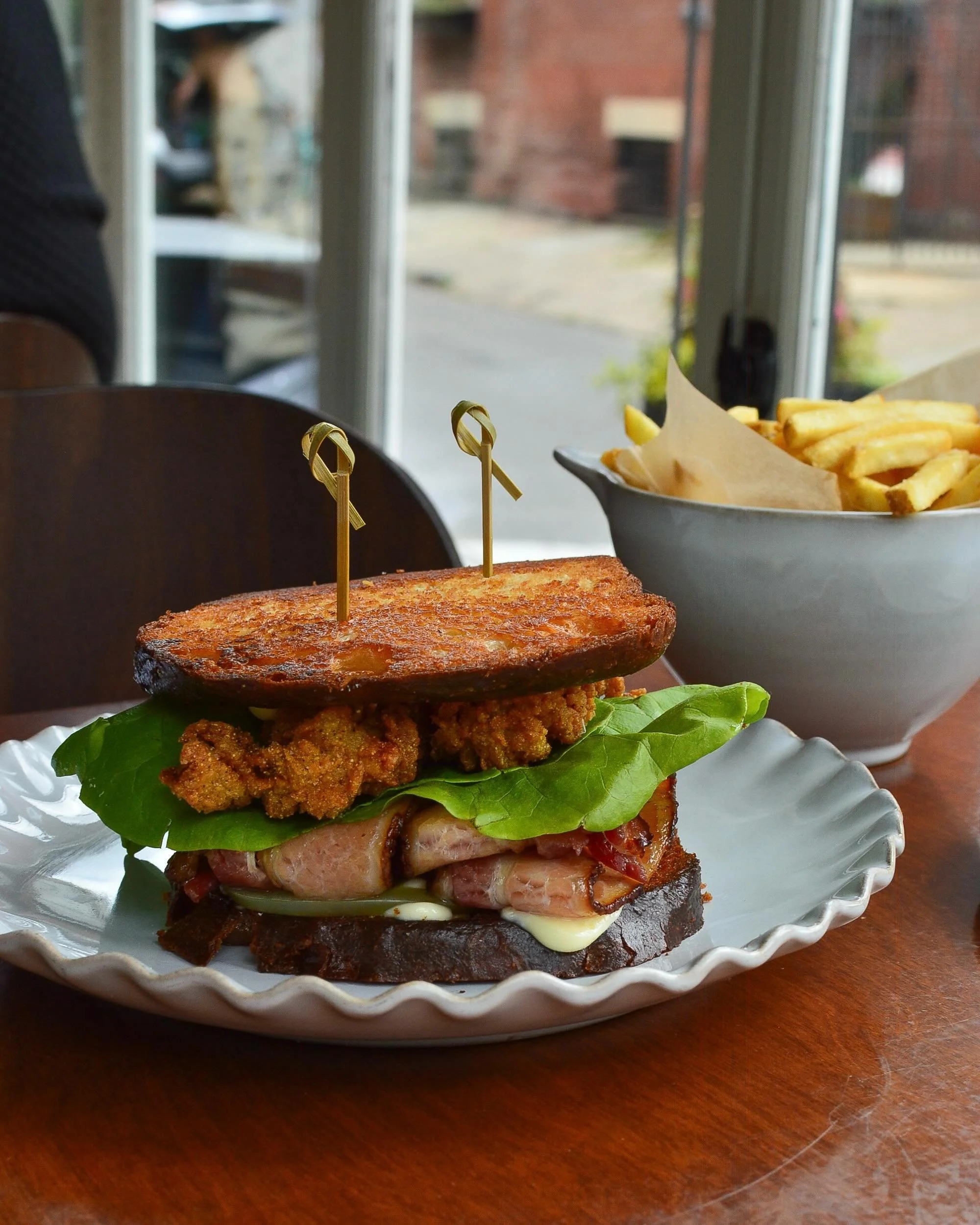 Fried oyster BLT with pickled green tomatoes, bibb lettuce and smoked bacon. Available for lunch and brunch!