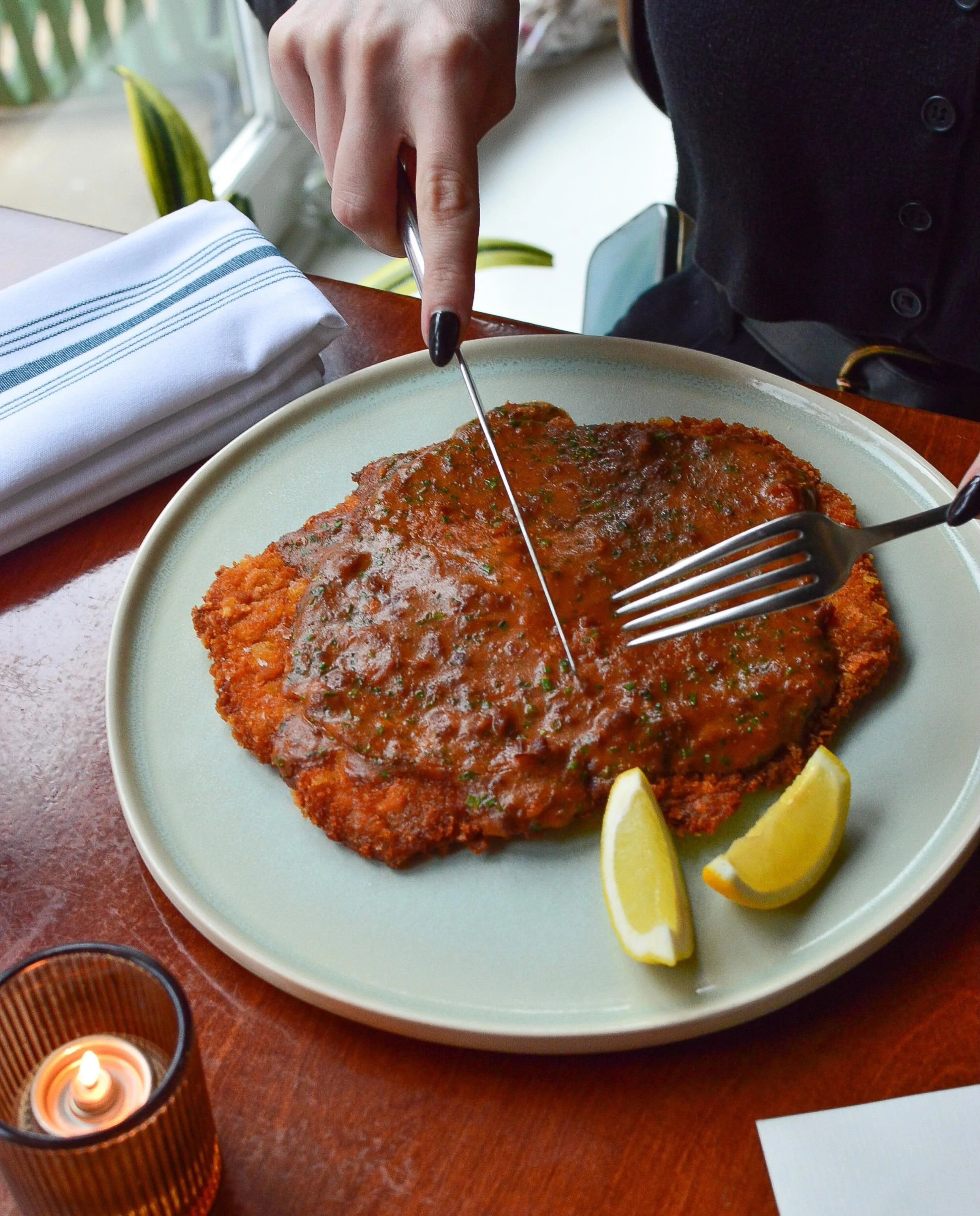 Pork Milanese with country ham xo, shellfish jus and fresh lemon.