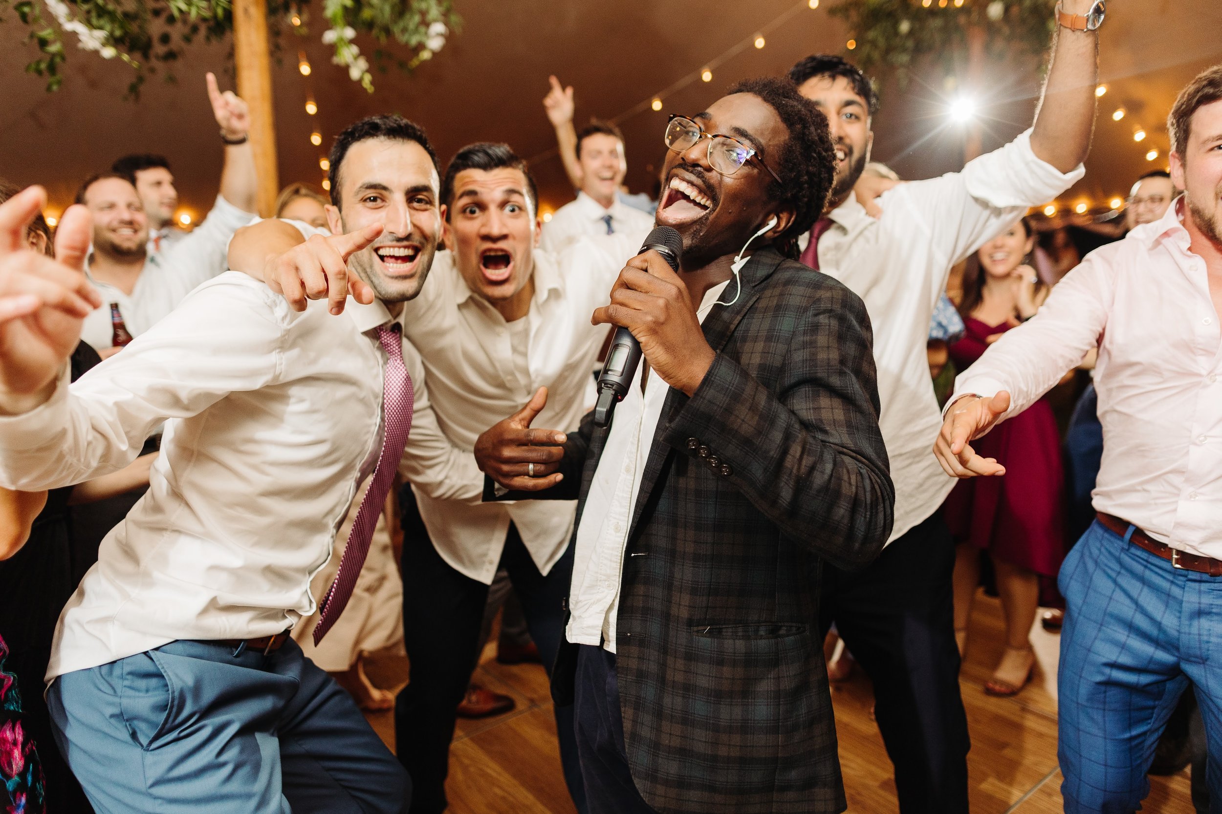 Groom sings with vocalist in party band for dance reception
