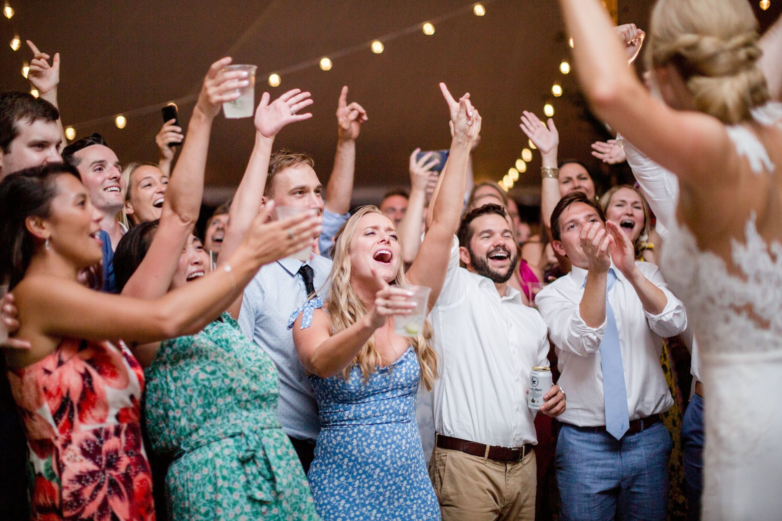 Wedding guests cheer for bride and party band