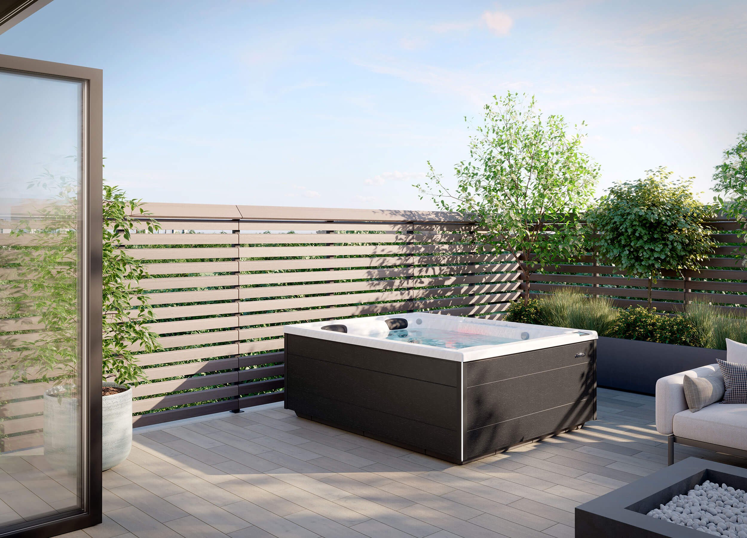 J404L™ Hot Tub set on residential backyard deck setting with slat fence and trees.
