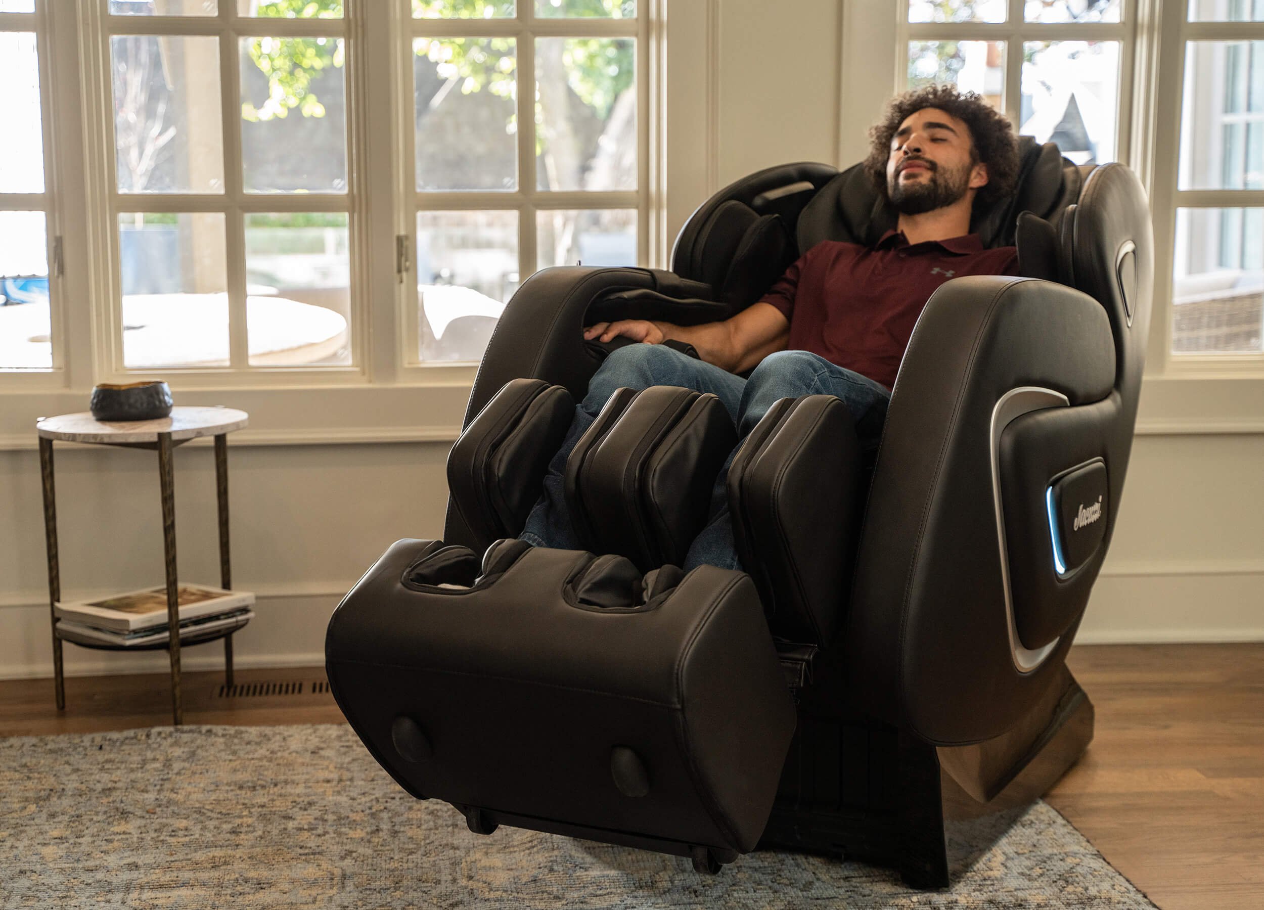 Man relaxing in a reclined massage chair in living room setting