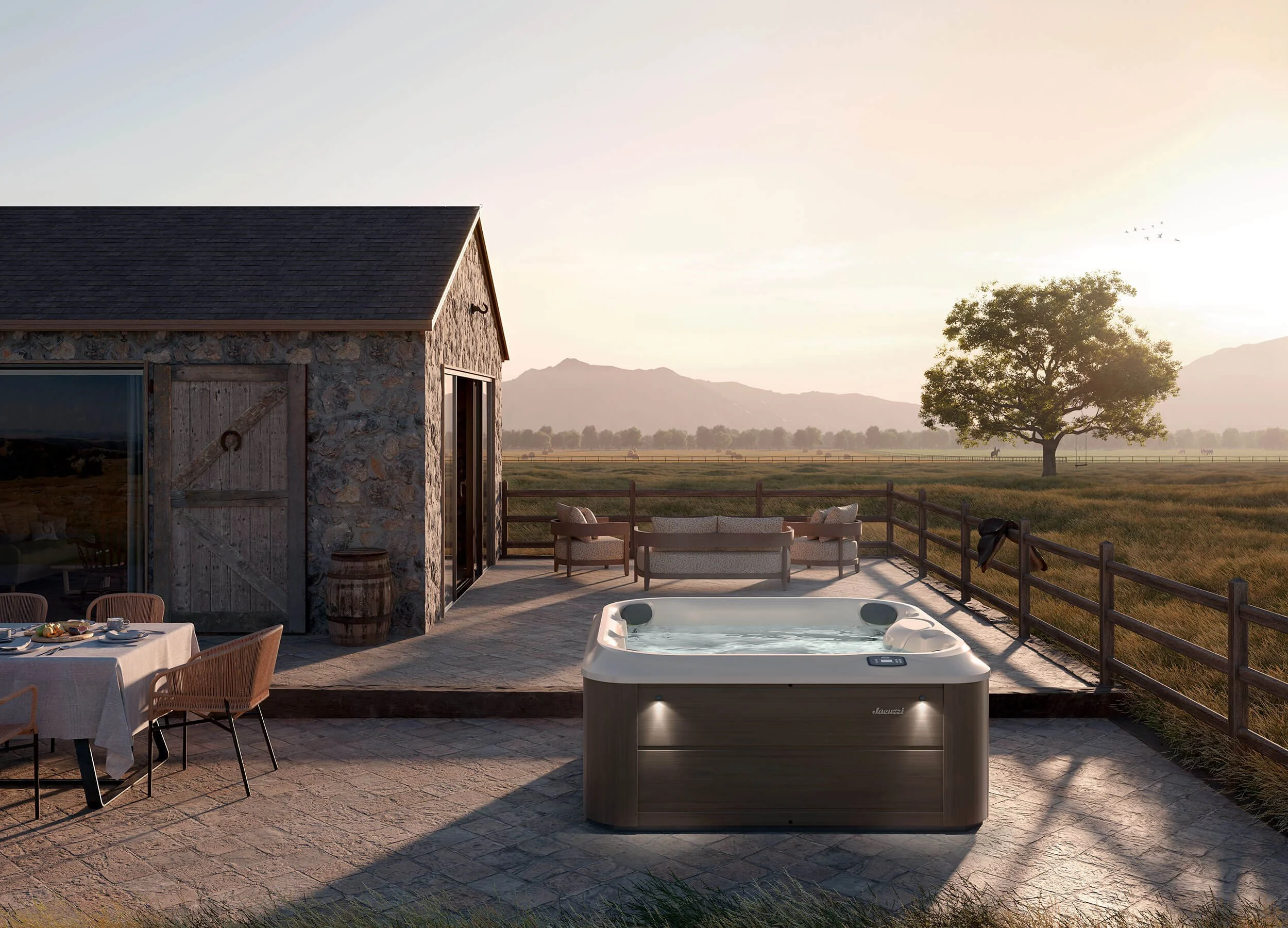 J-200™ Series hot tub on concrete patio with pastoral view
