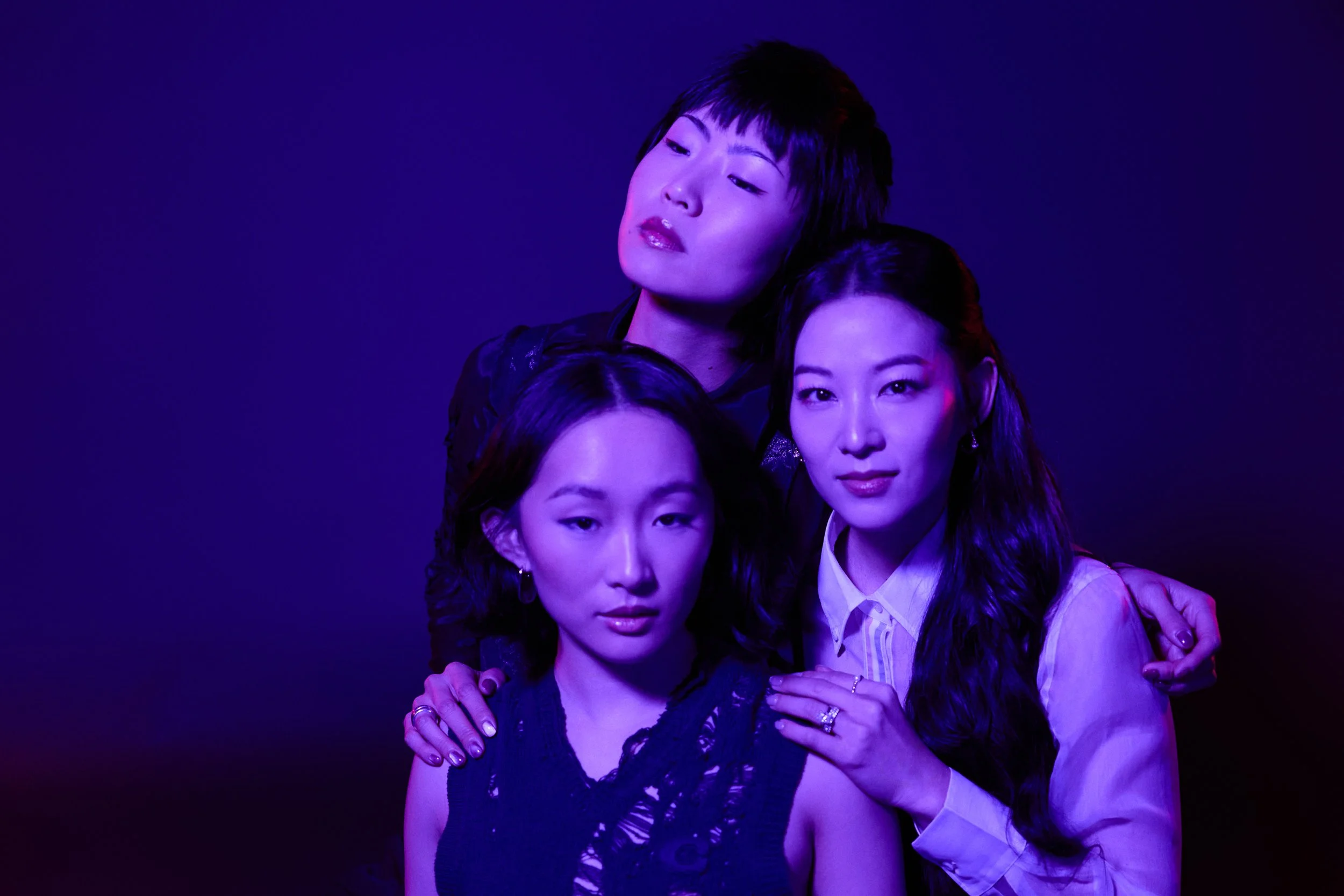 K-pop demon hunters photoshoot blends high-fashion editorial styling with dark fantasy aesthetics. Inspired by the K-Pop Demon Hunter aesthetic, the shoot features bold makeup, dramatic lighting, and powerful group poses. Black leather, white accents