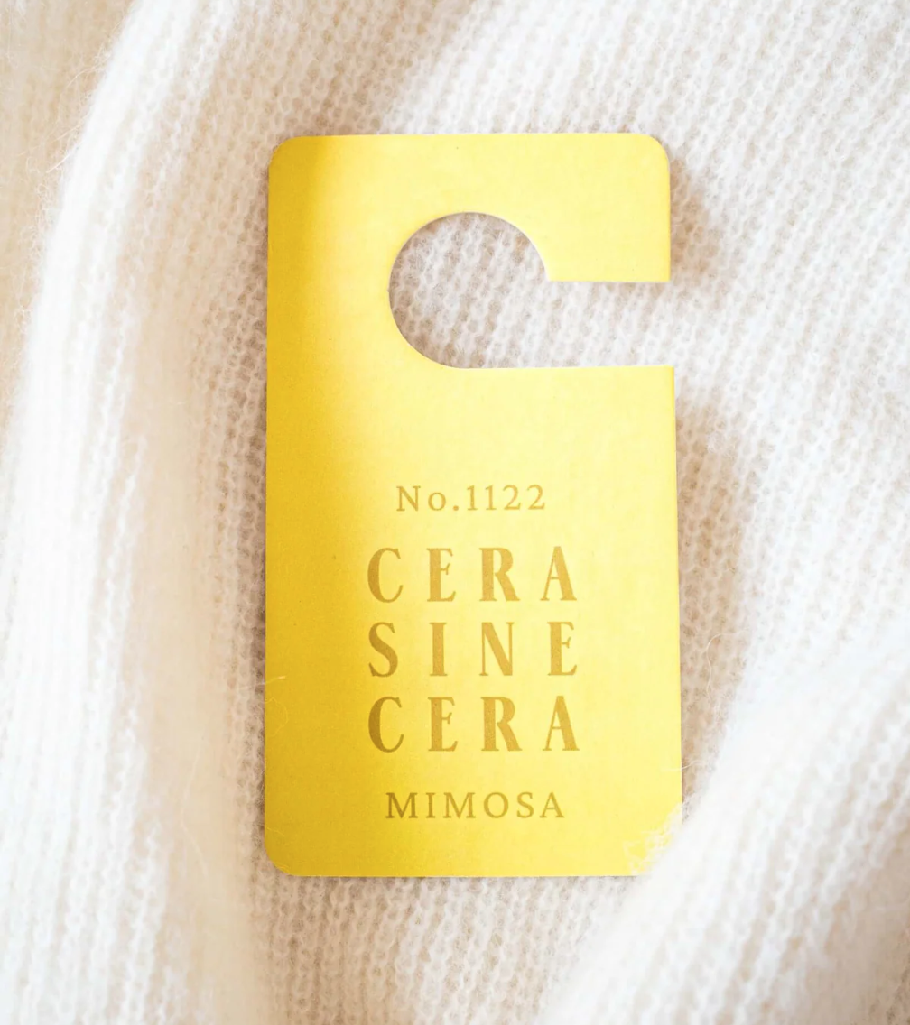 Floral fragrance tag for closet and bag, styled with polished nails and hand care essentials. Aesthetic accessory for nail salon clients and beauty lovers like Mellow Bar.