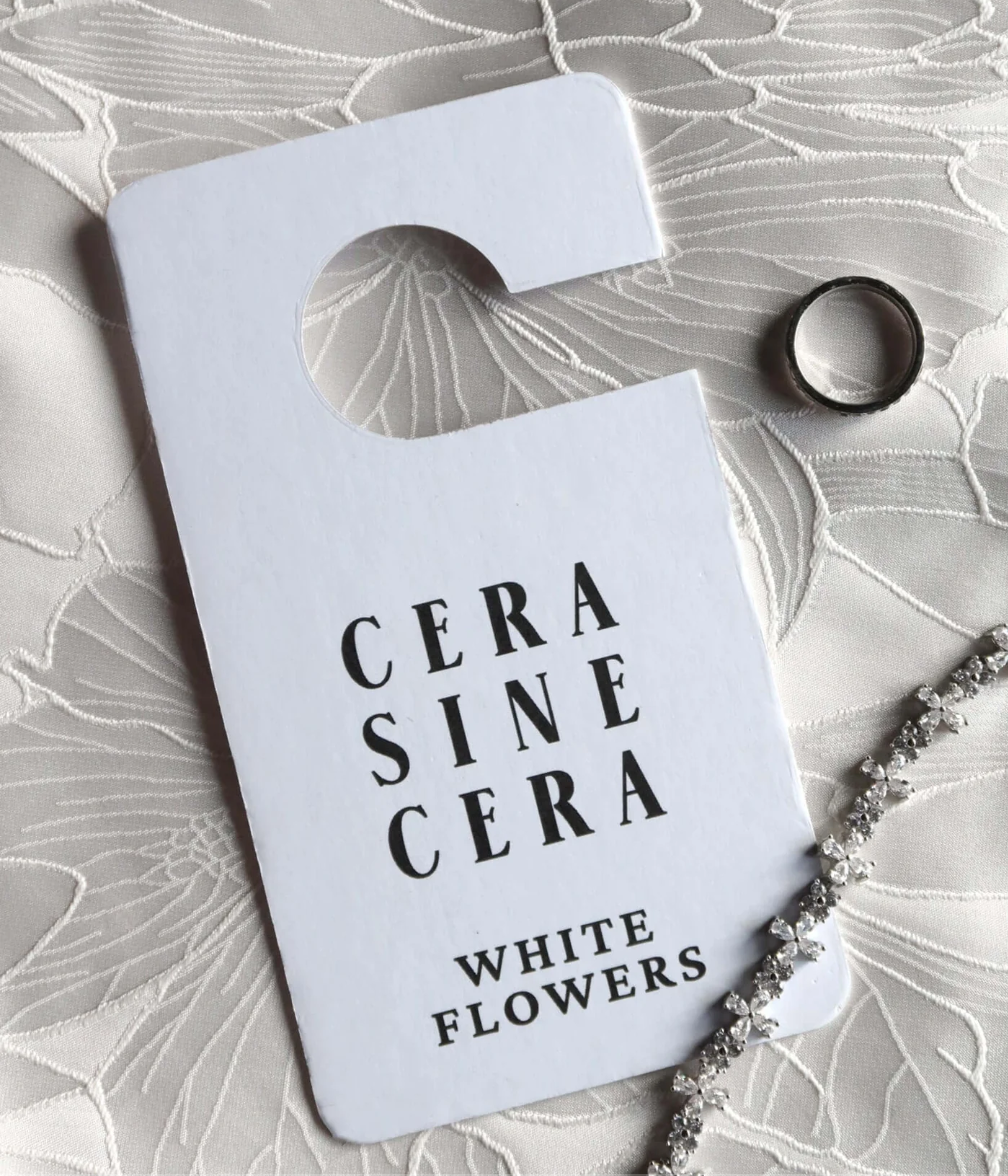 Floral fragrance tag for closet and bag, styled with polished nails and hand care essentials. Aesthetic accessory for nail salon clients and beauty lovers like Mellow Bar.