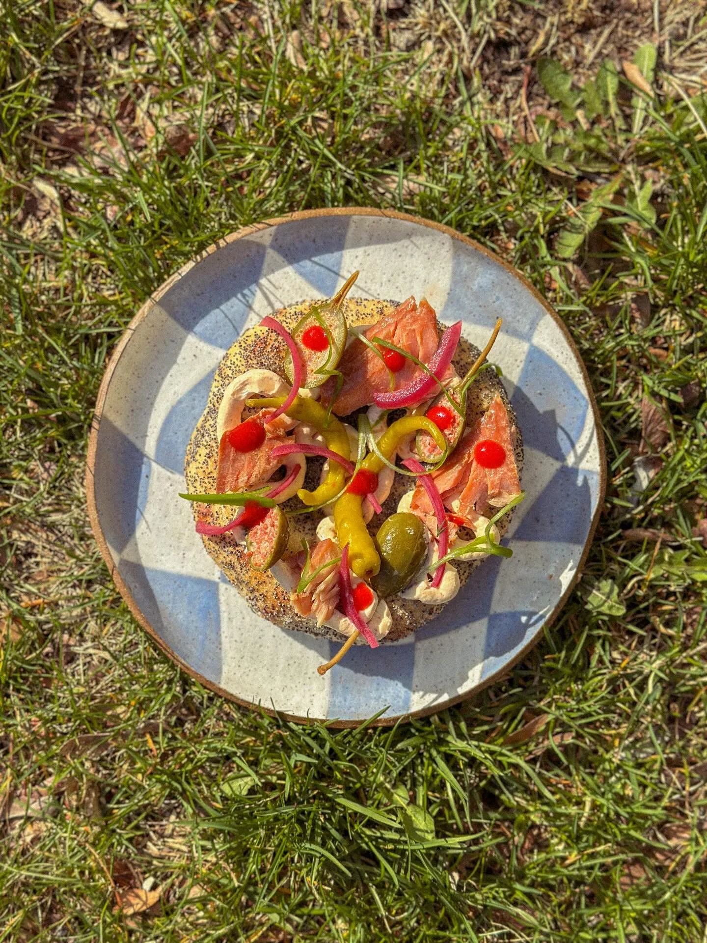 bialy every friday and this week we are topping them with spicy cream cheese, @fishwife smoked rainbow trout, our house hot sauce, and the necessary pickles