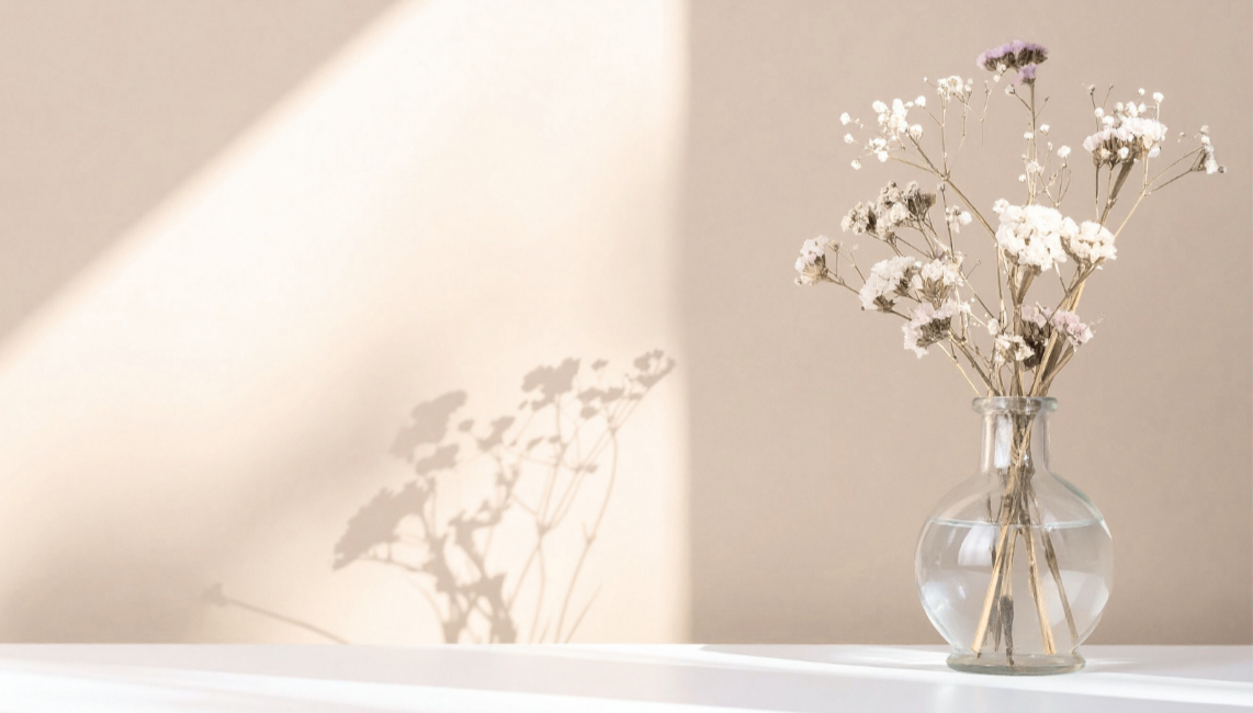 Soft neutral-toned flowers in a glass vase representing grounding and neurodivergent-affirming counselling for AuDHD adults at Neurodiversity Wellness Collective.