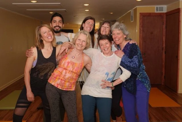 A yoga crew hugging each others as a team