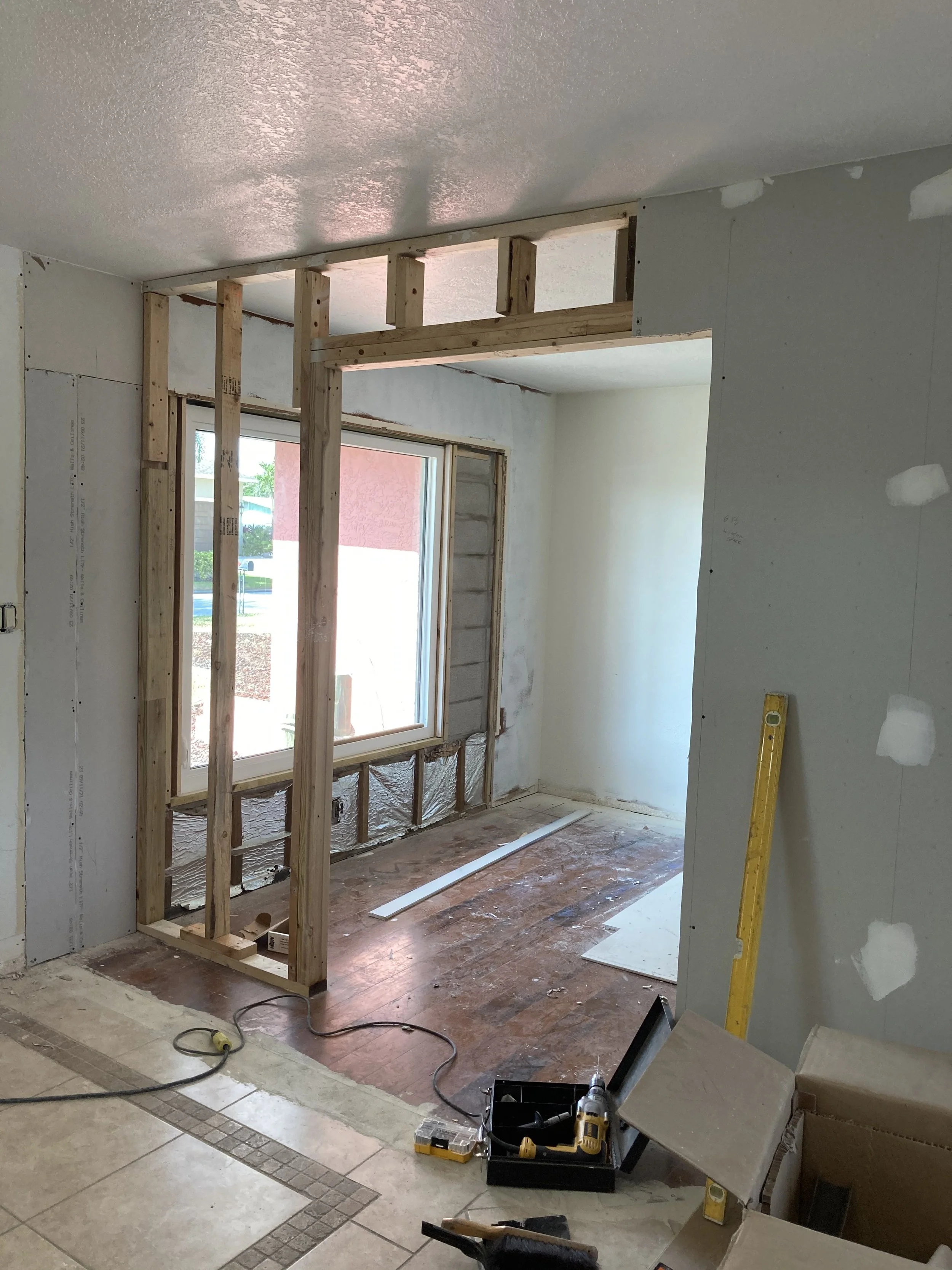 Remodeled living area by reframing wall to install french doors and new window in Bradenton, FL