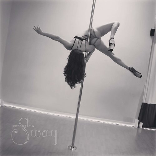 Woman doing pole trick at Entangle + Sway.