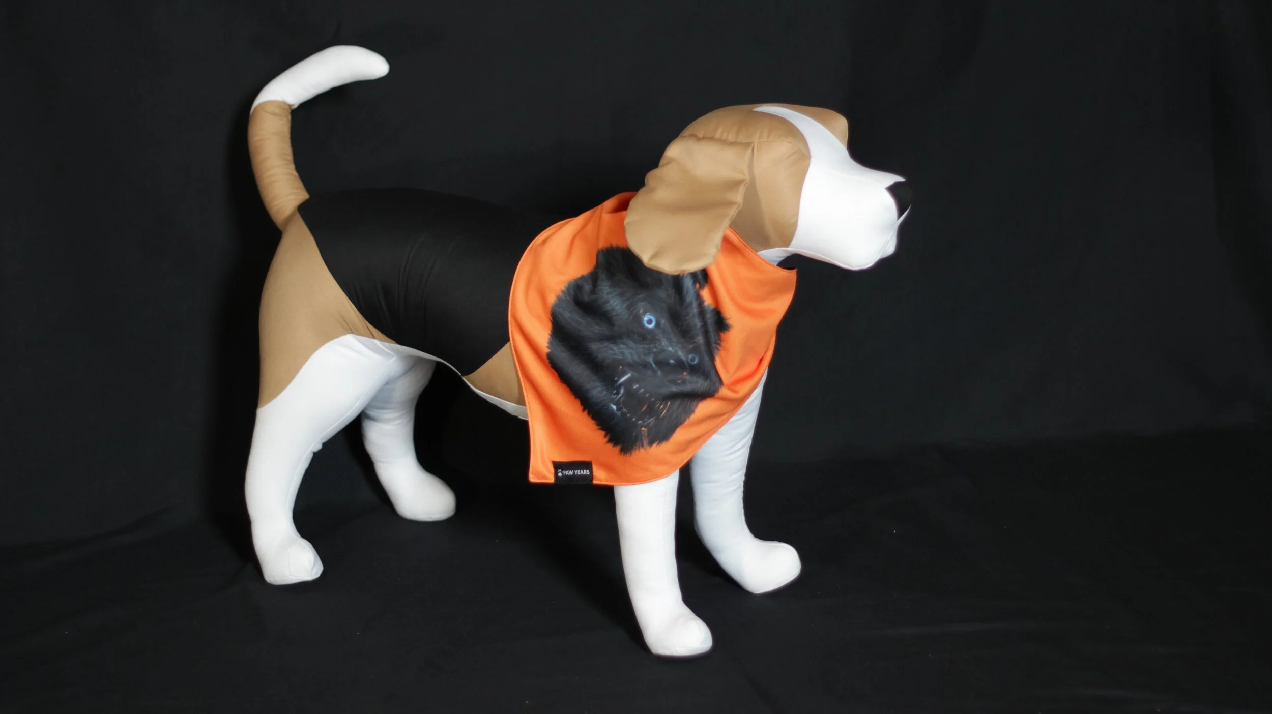 Side view of dog mannequin wearing orange Lycan bandana featuring black wolf art.