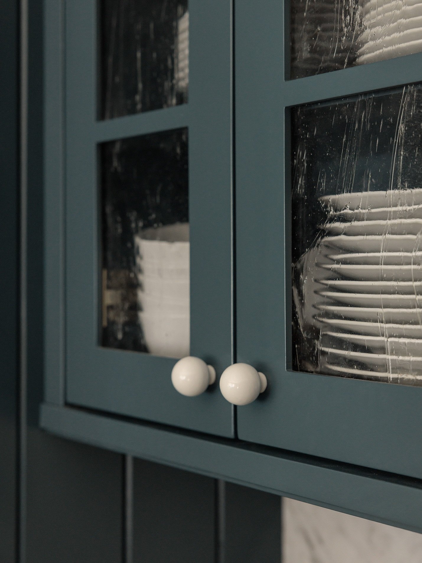 A quiet but favorite detail of mine from our wooden delight project, why not choose a fun glass for upper cabinets? 

Fun fact, this water glass detail was taken from the original front door in the house. A thoughtful little detail carried over to th