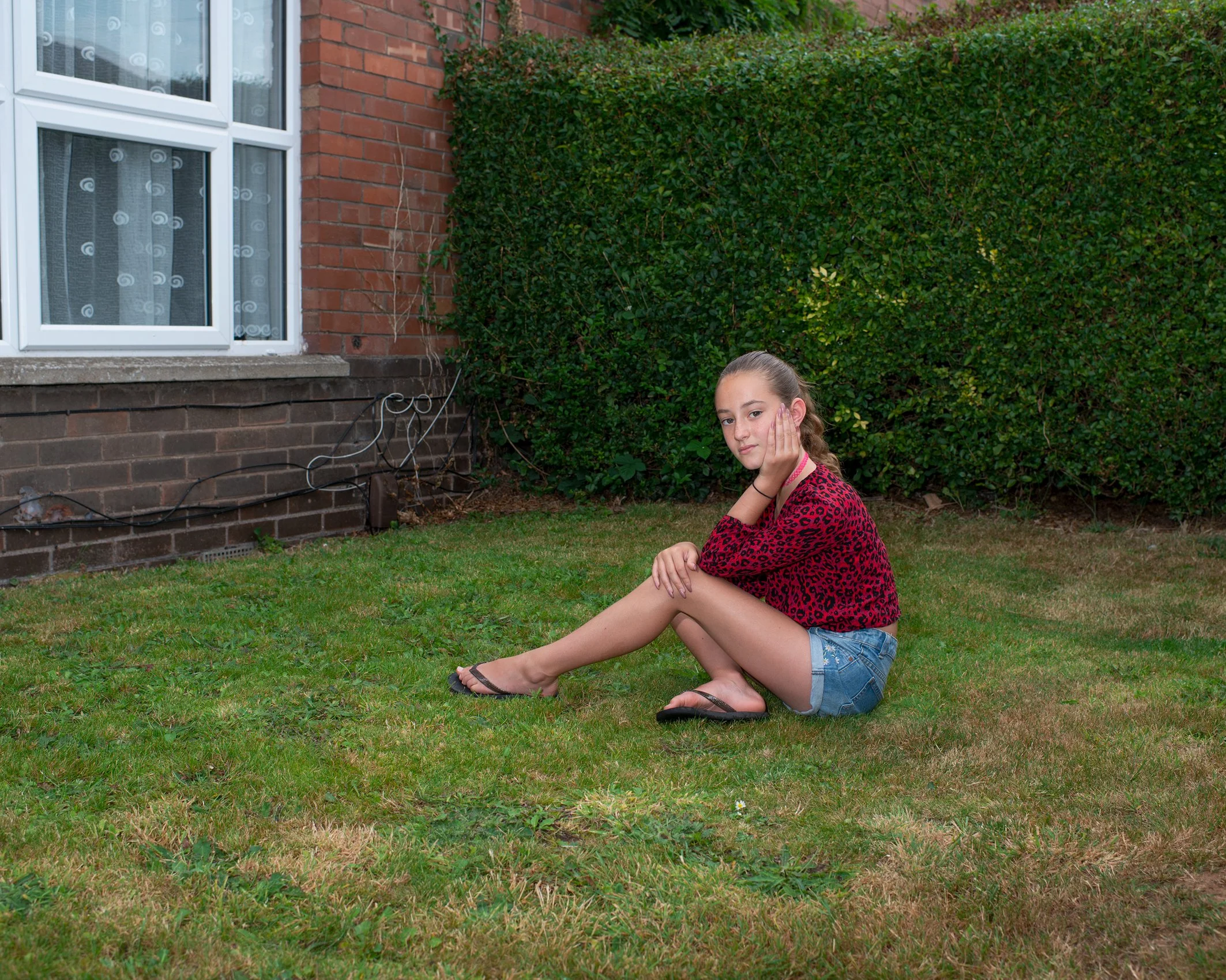 Young girl in her front garden
