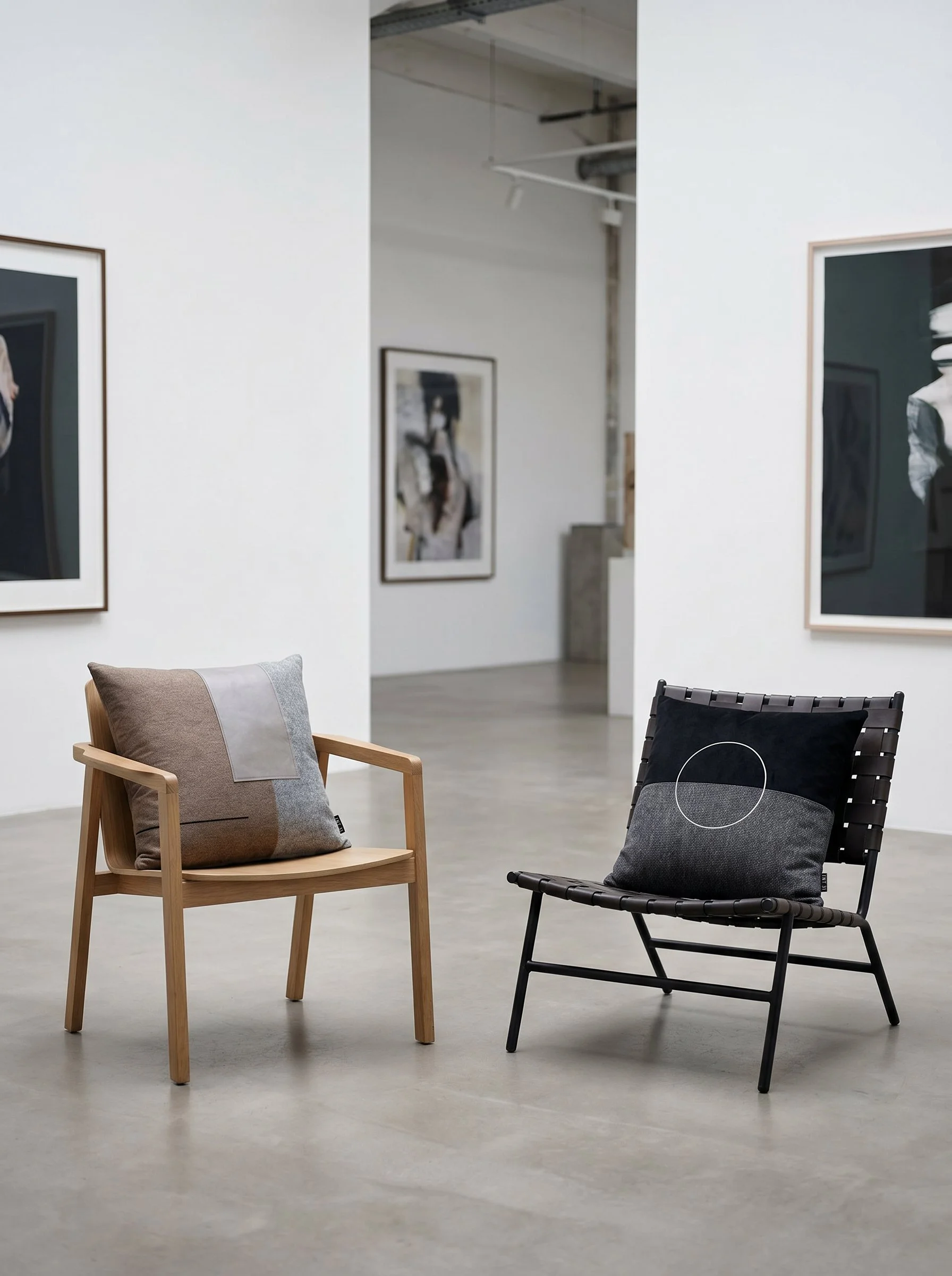 Generated-with-Kive.ai---GALLERY-SHOWROOM-large-20-x-20-inch-cushion-ELAMA_01-and-20-x-20-inch-cushion-LUAR_01-each-on-a-modern-chair-in-a-gallery.jpg