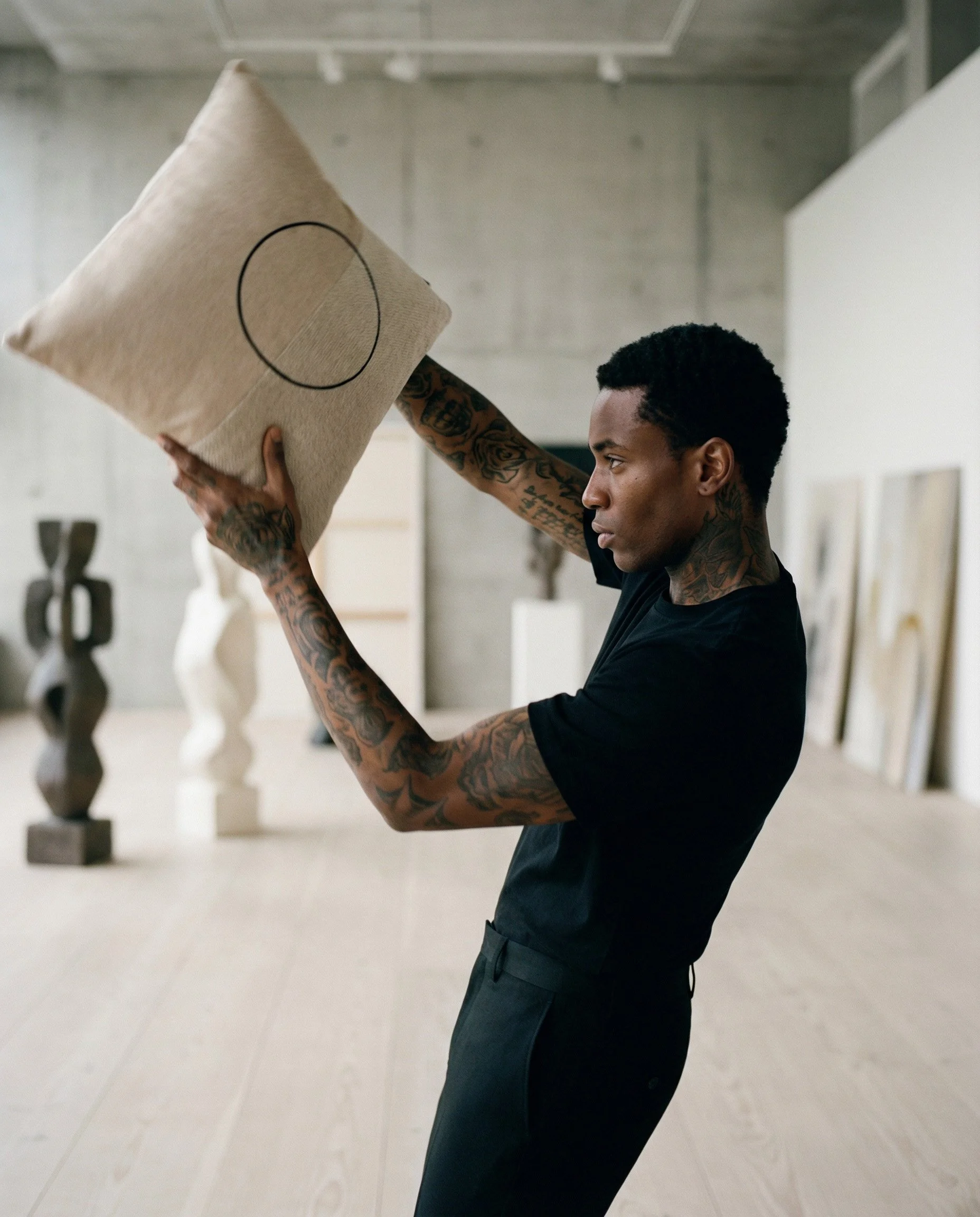 tattooed black man in a gallery with LUAR_03 pillow.jpg