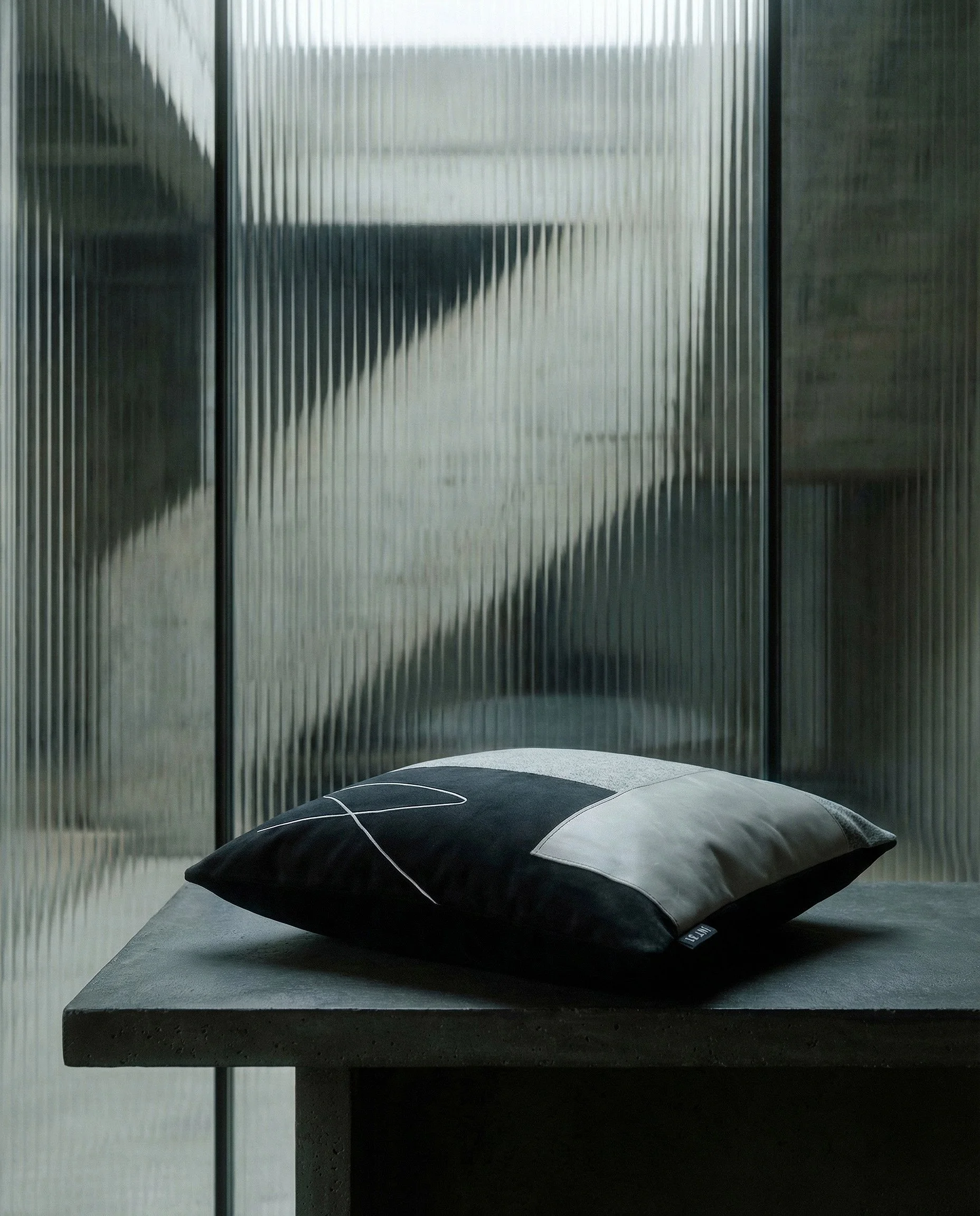 brutalist room with USKO_03 on a table infront of ribbed glass product shot (2).jpg