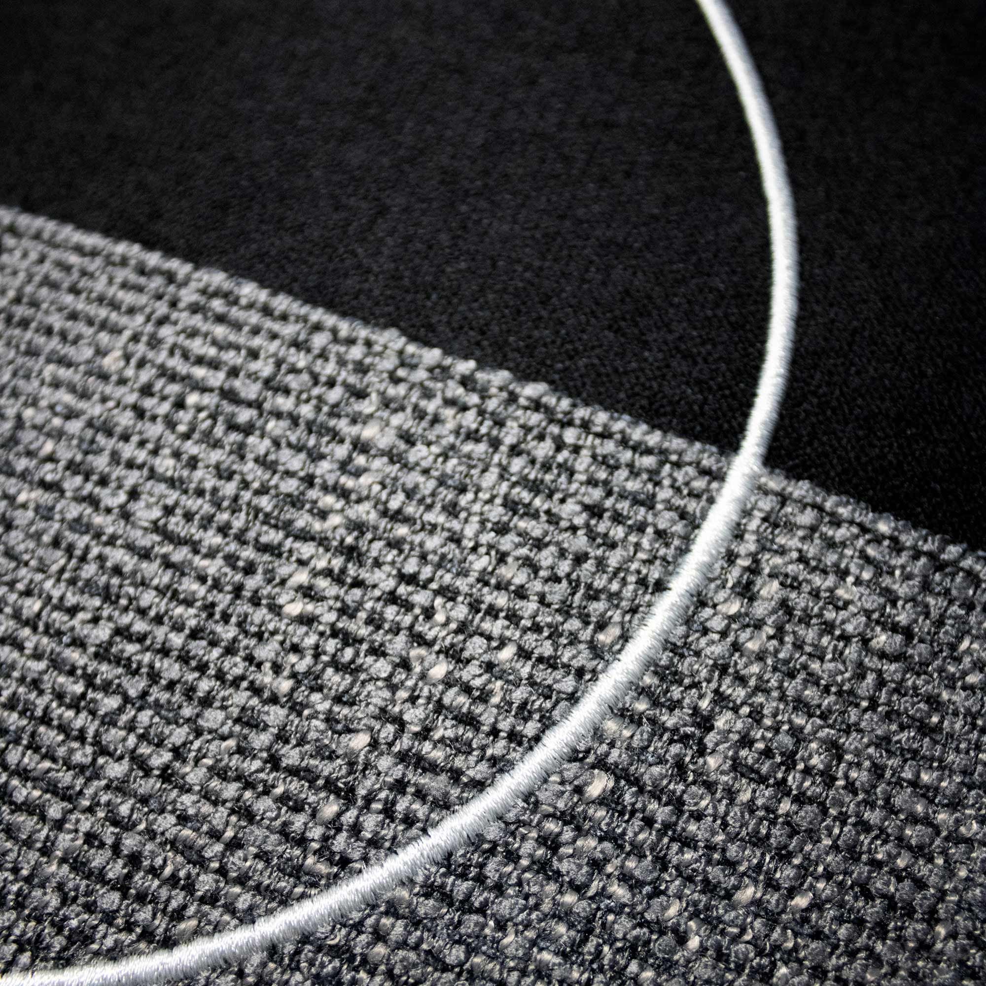 LUAR_01 decorative cushion in black and grey textile with light grey circular embroidery detail