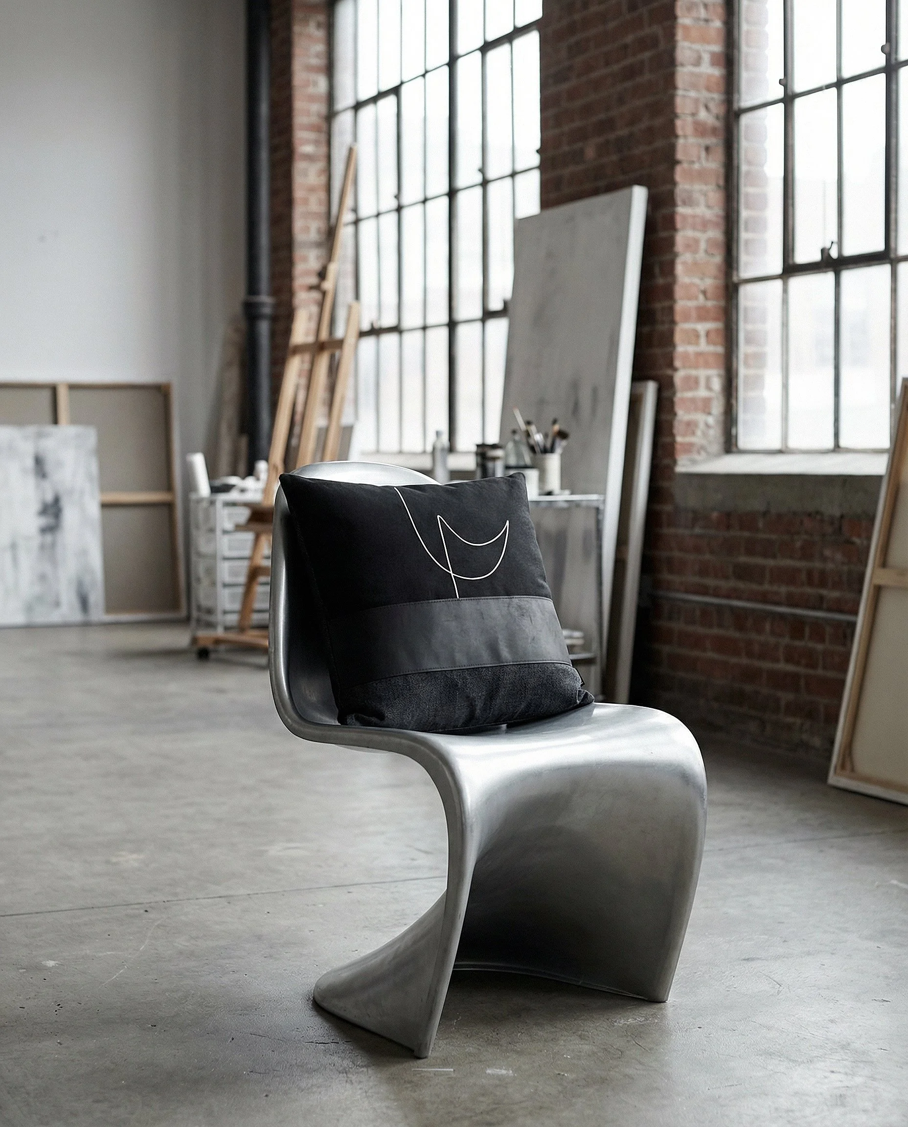 pillow RAIO_01 on a modern silver chair.jpg