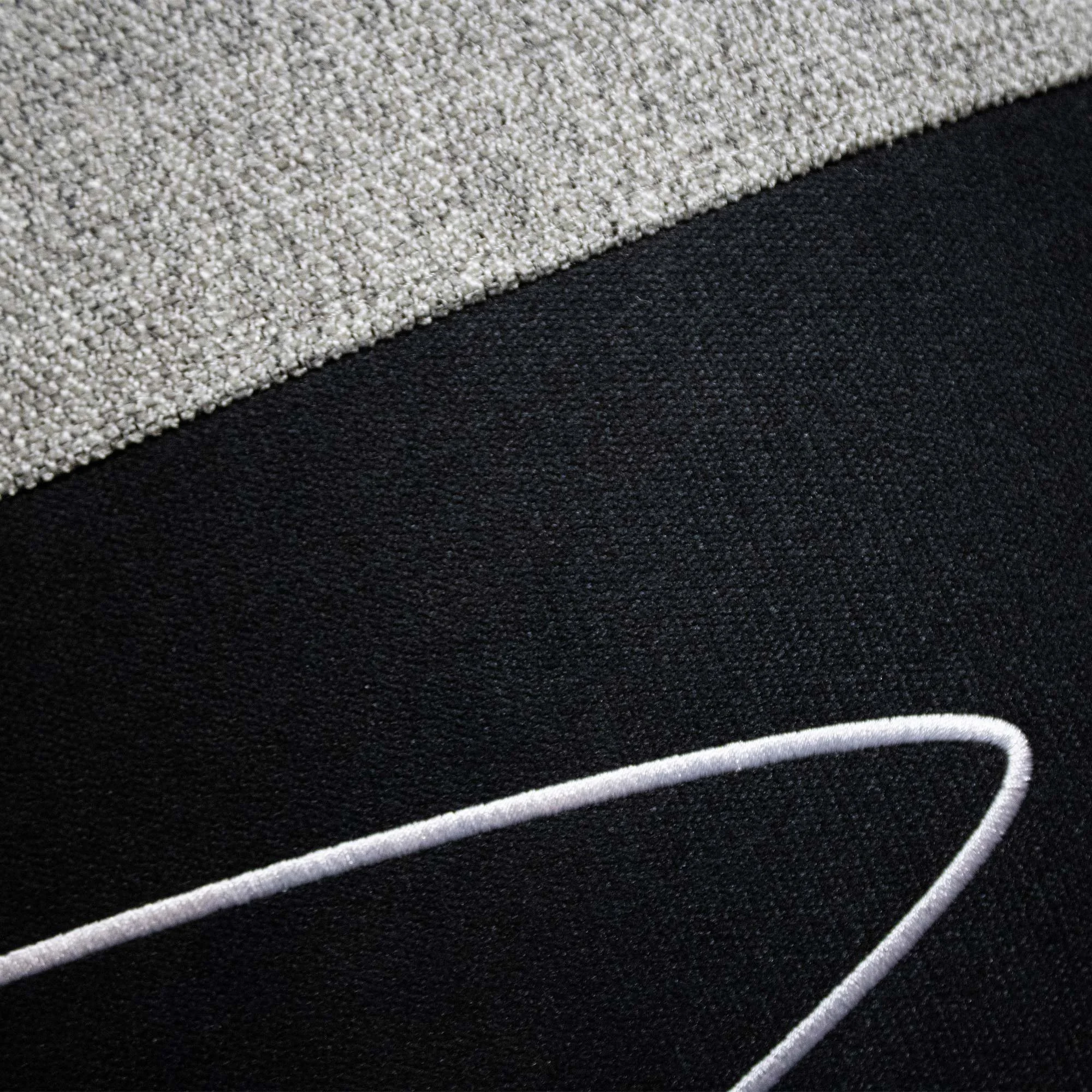 USKO_03 decorative cushion in grey and black textile with light grey leather panel and white abstract embroidered detail