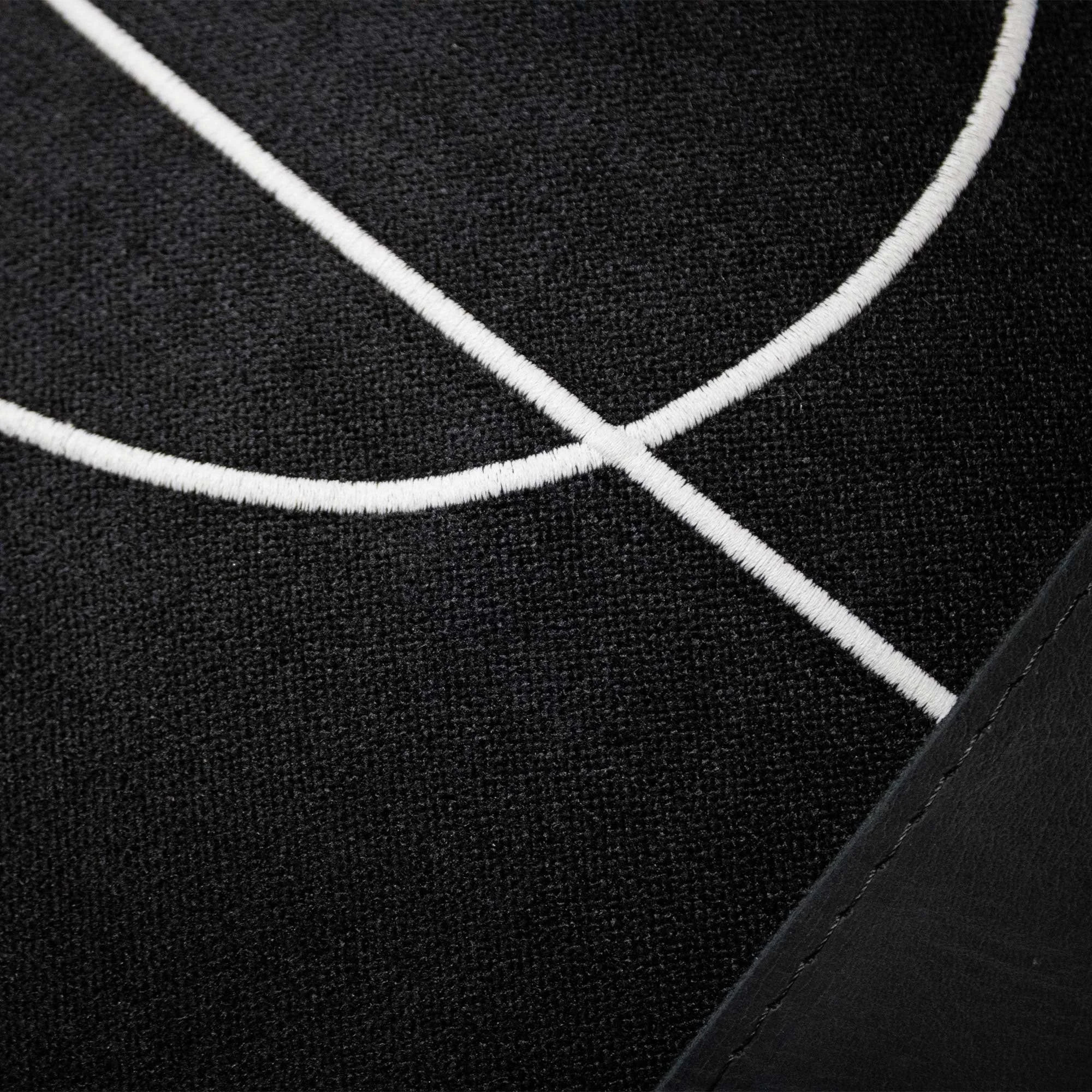 RAIO_01 decorative cushion in black textile with black leather panel and abstract light grey embroidered line detail