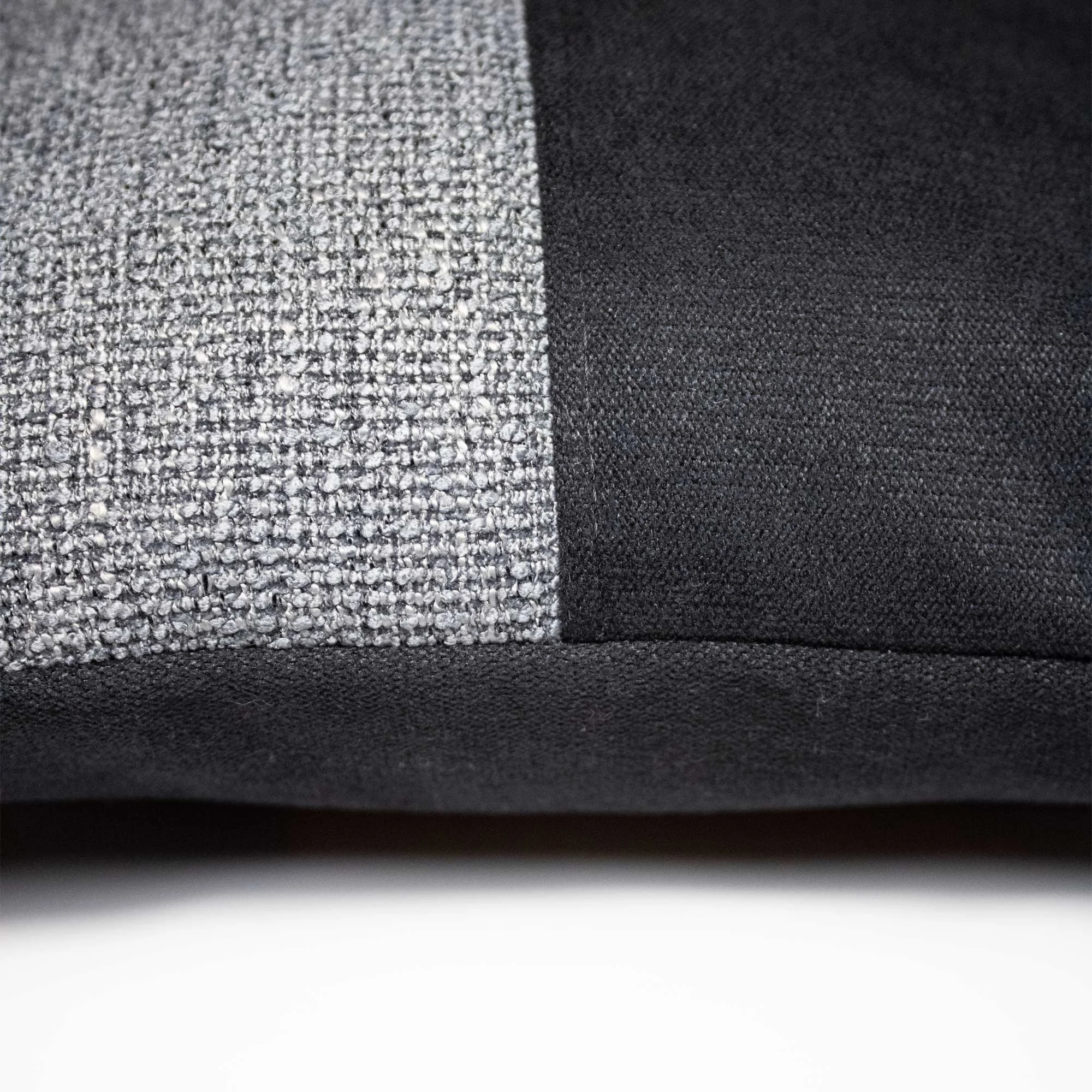 NASARA_02 decorative cushion in black and grey textile with light grey leather panel and vertical yellow stitched detail