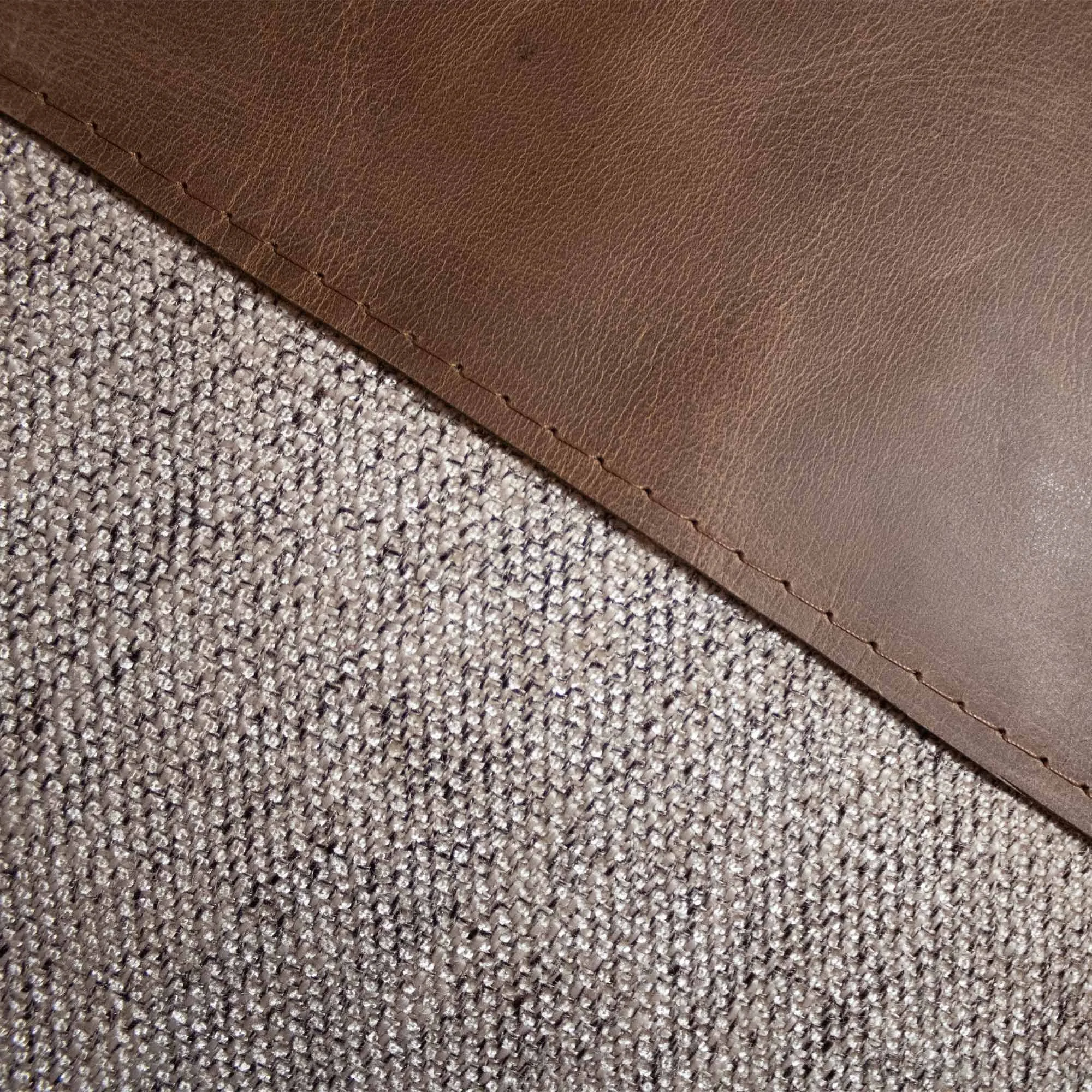 RAIO_03 decorative cushion in brown tonal textile with brown leather panel and abstract beige embroidered line detail