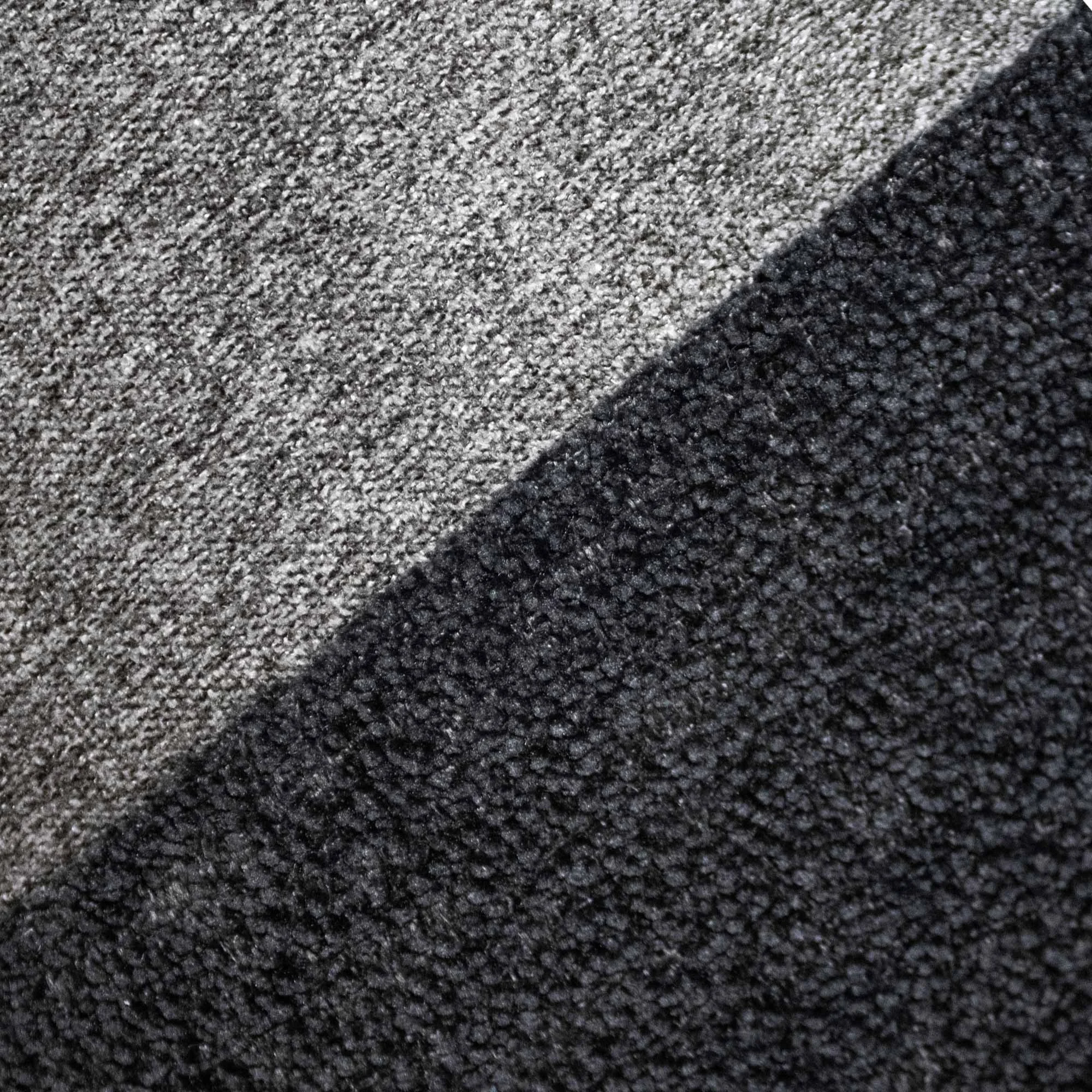 AIRE_03 grey and black textile cushion with minimalist white embroidered line design