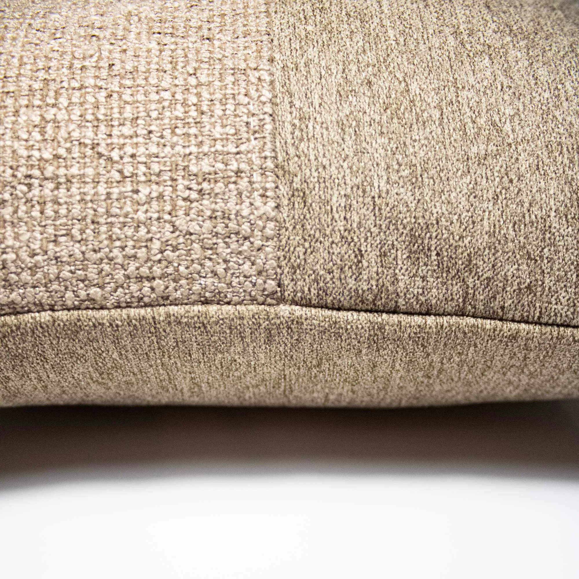 NASARA_01 decorative cushion in brown tonal textiles with black leather panel and vertical coral stitched detail