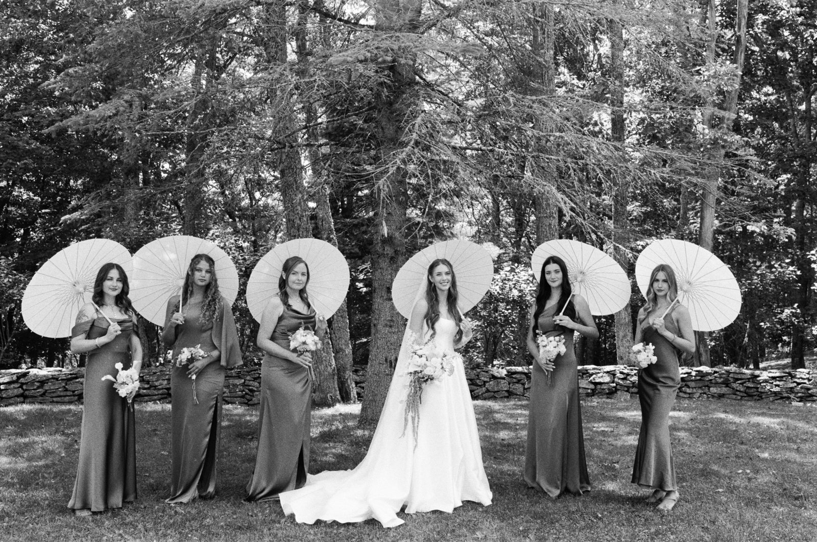 bridal party with parasols on black and white film