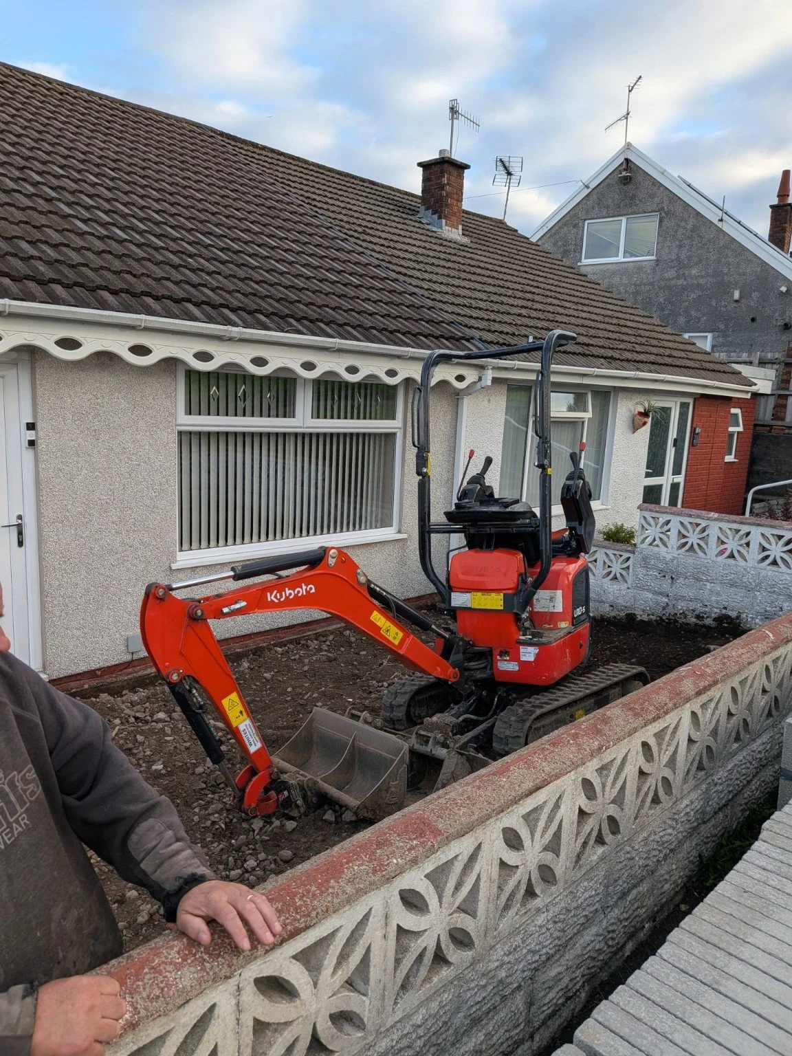 Compact Kubota excavator working between a house and boundary wall in Blackwood