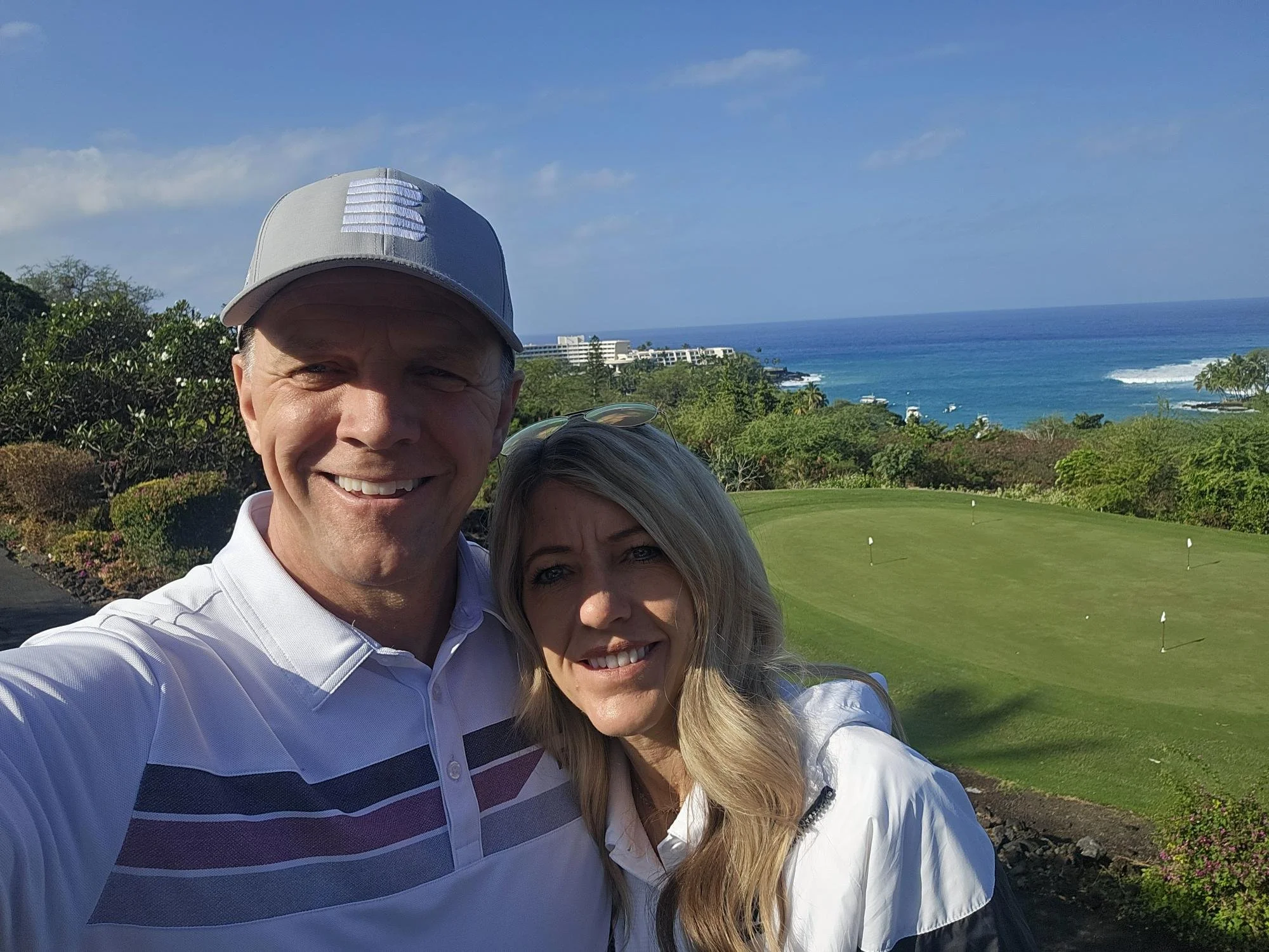 Happy married man and woman connecting on the golf course in Kona