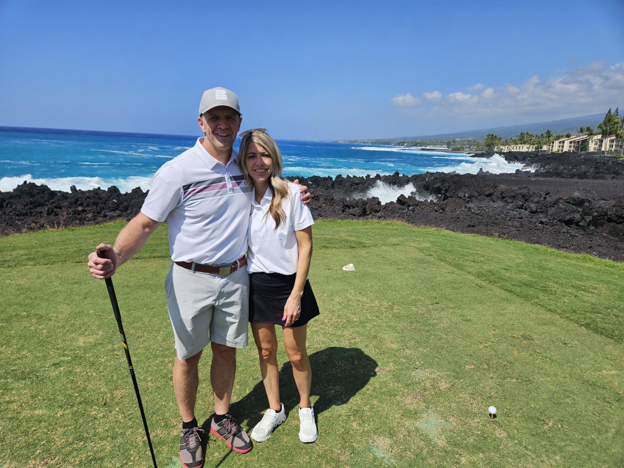 Happy married man and woman connecting on the golf course in Kona