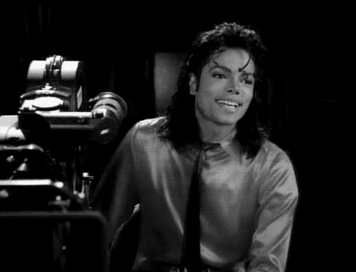 GIF of Michael Jackson smiling hard