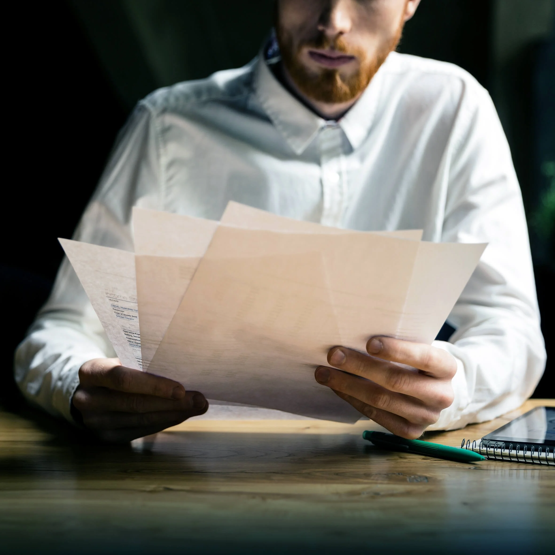 A business person looking over paperwork regarding to Voqa's commercial EV charging solutions