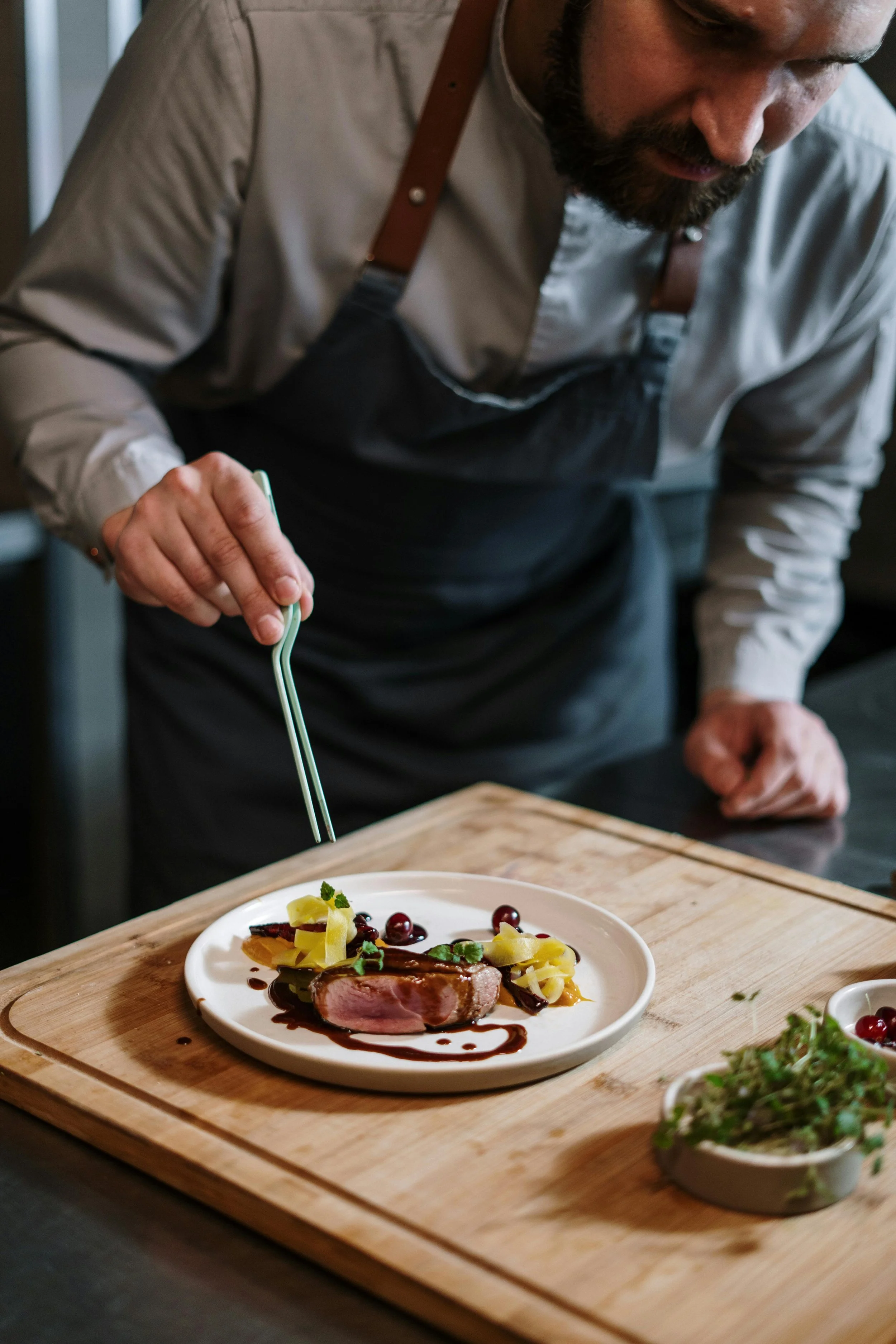 Experienced yacht chef plating fine dining dish onboard superyacht