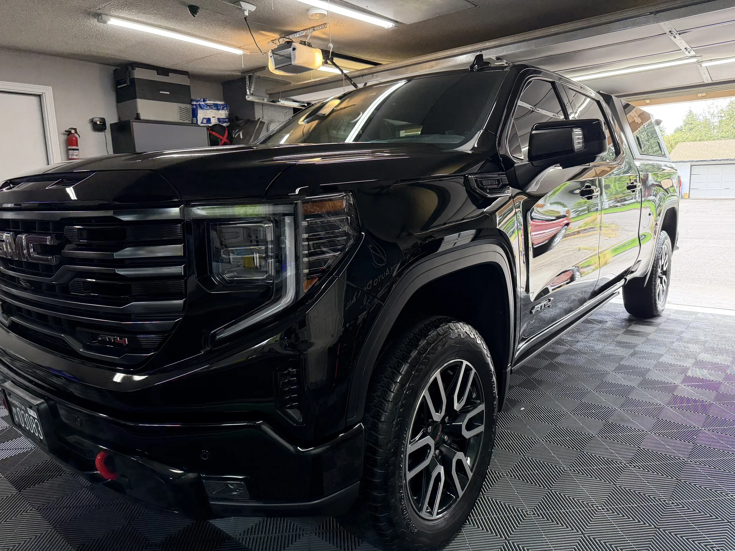 Black GMC Sierra pickup with a clean, glossy exterior after auto detailing.