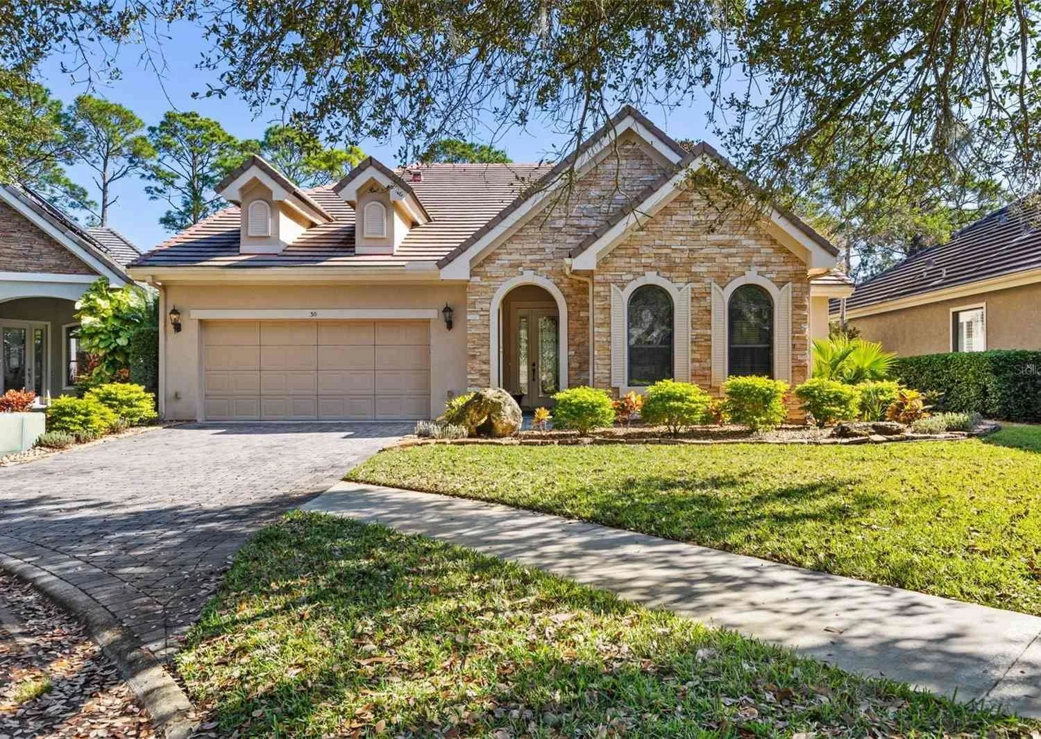 Home in Grand Haven Palm Coast golf course community surrounded by trees