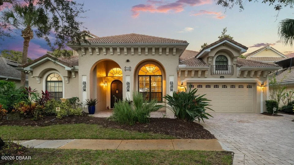 Grand Haven Palm Coast home exterior at sunset with warm lighting