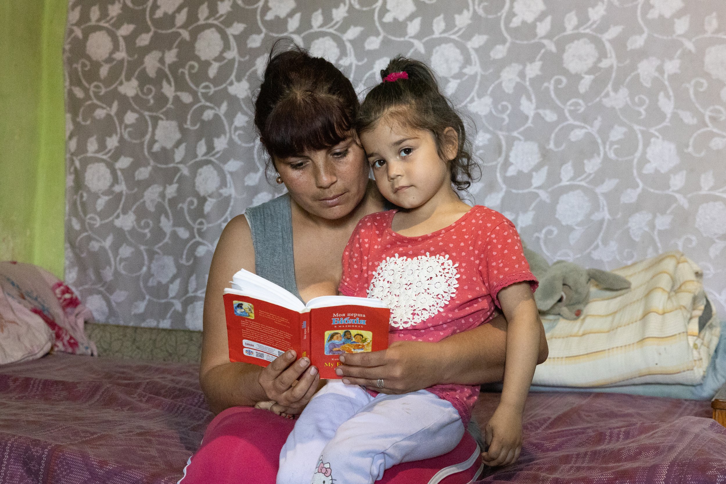 Olena and daughter reading.jpg