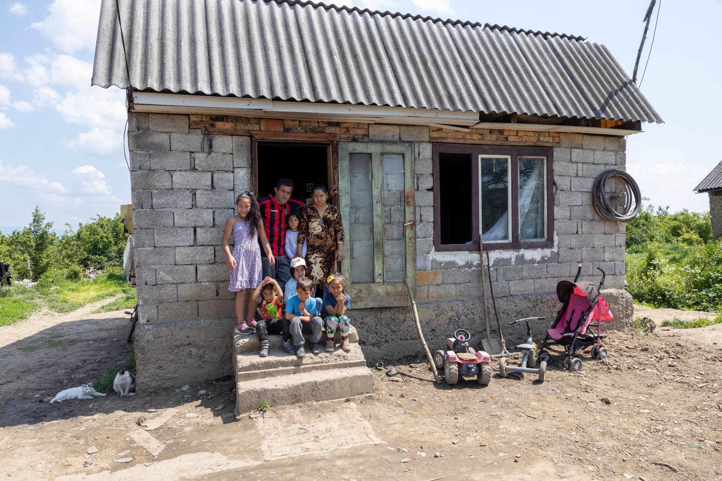 Albert + Csilia on the steps of their house with some of their children.jpg