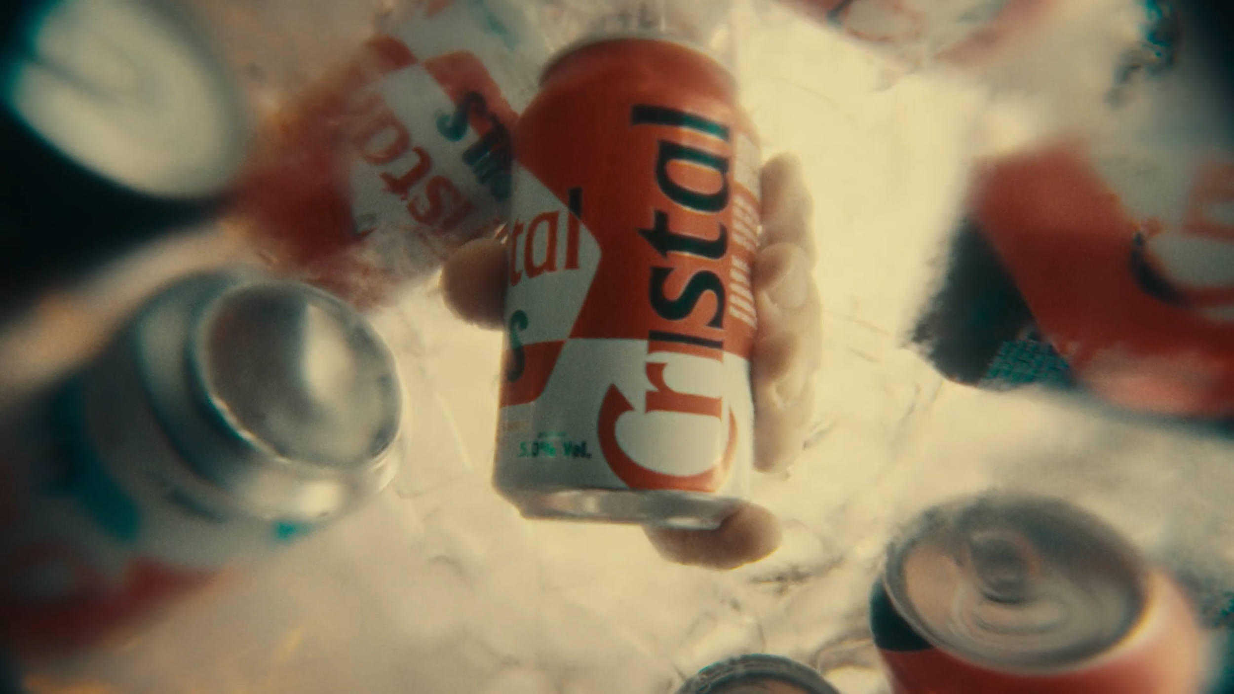 A person holding a can of Dr. STRONG soda under water with other cans around, creating a swirling water effect.