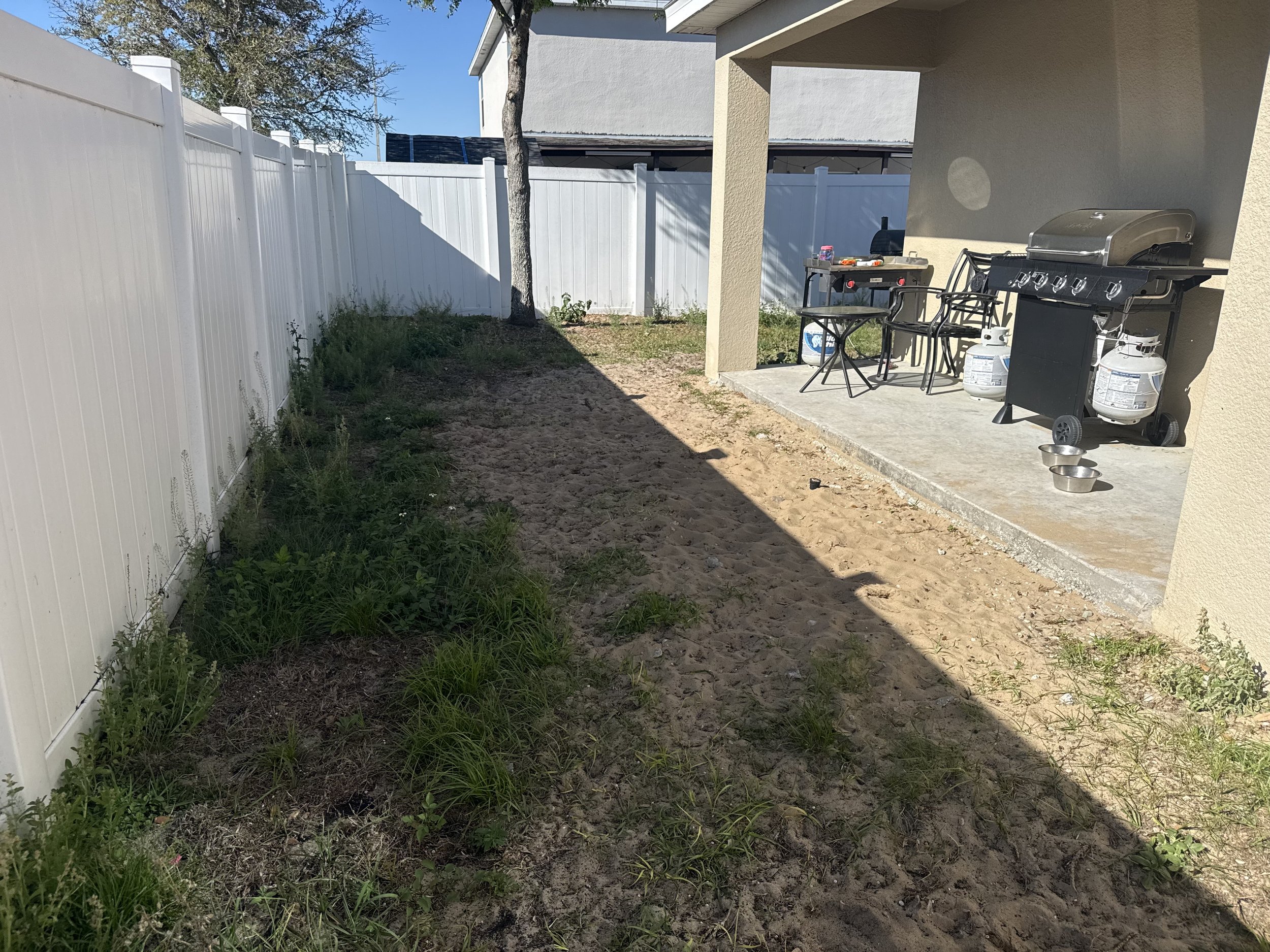 Unfinished dirt backyard patio area before concrete pour in Davenport FL