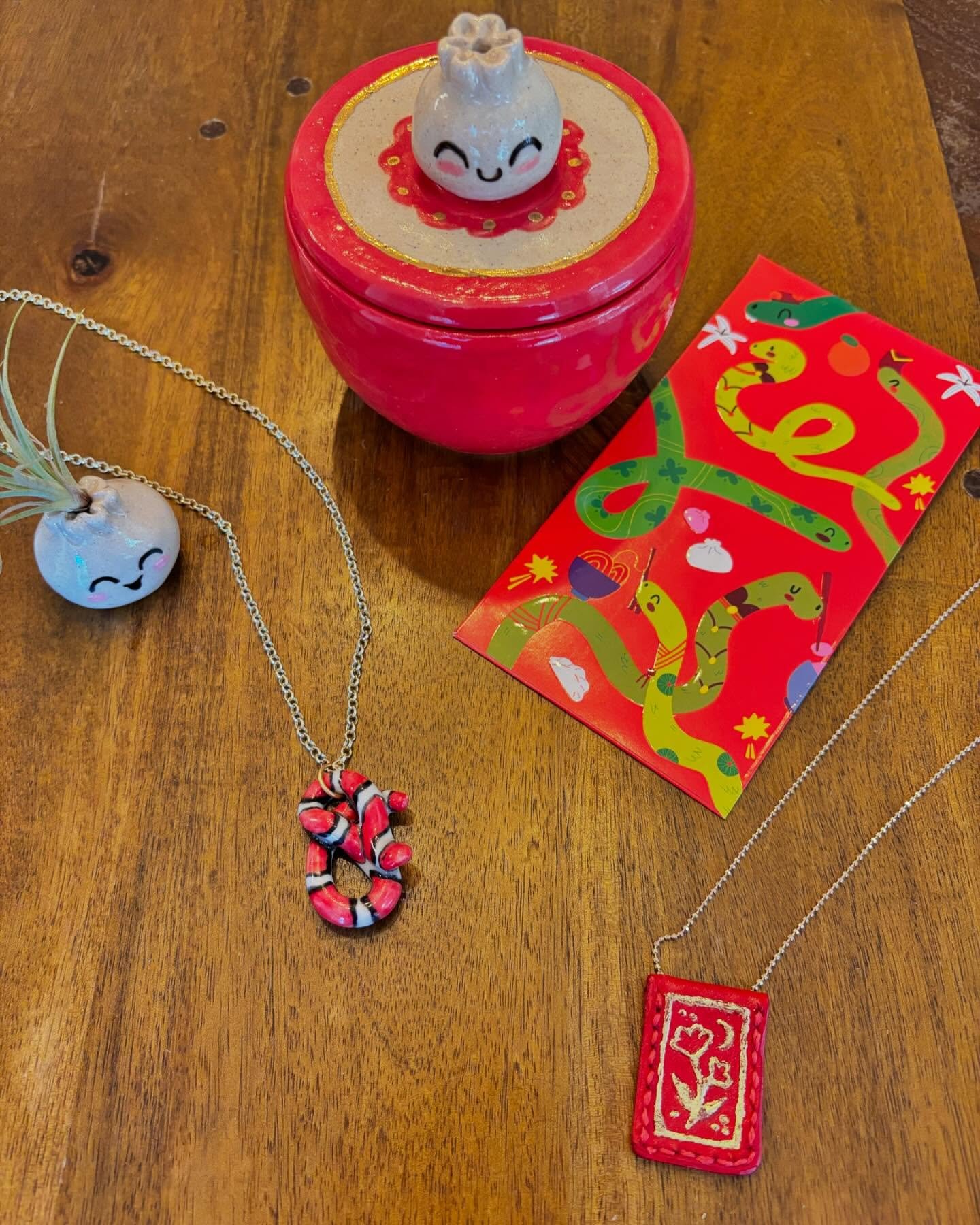 Happy Lunar New Year!!!🧧 🐍  I created two fun necklaces this year to celebrate! I crafted a leather money envelope that I gold leafed (A technique I was playing around with please don&rsquo;t judge) and I also sculpted a porcelain snake pendant whi