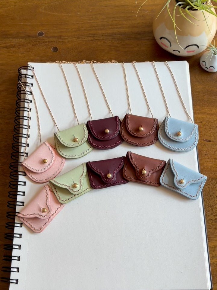 I just finished hand stitching up these fun leather charms. Pouchies can really open to store your small trinkets inside. They are perfect for crafty people who might want to put their ring away safely while they play with clay or for guitarists to h