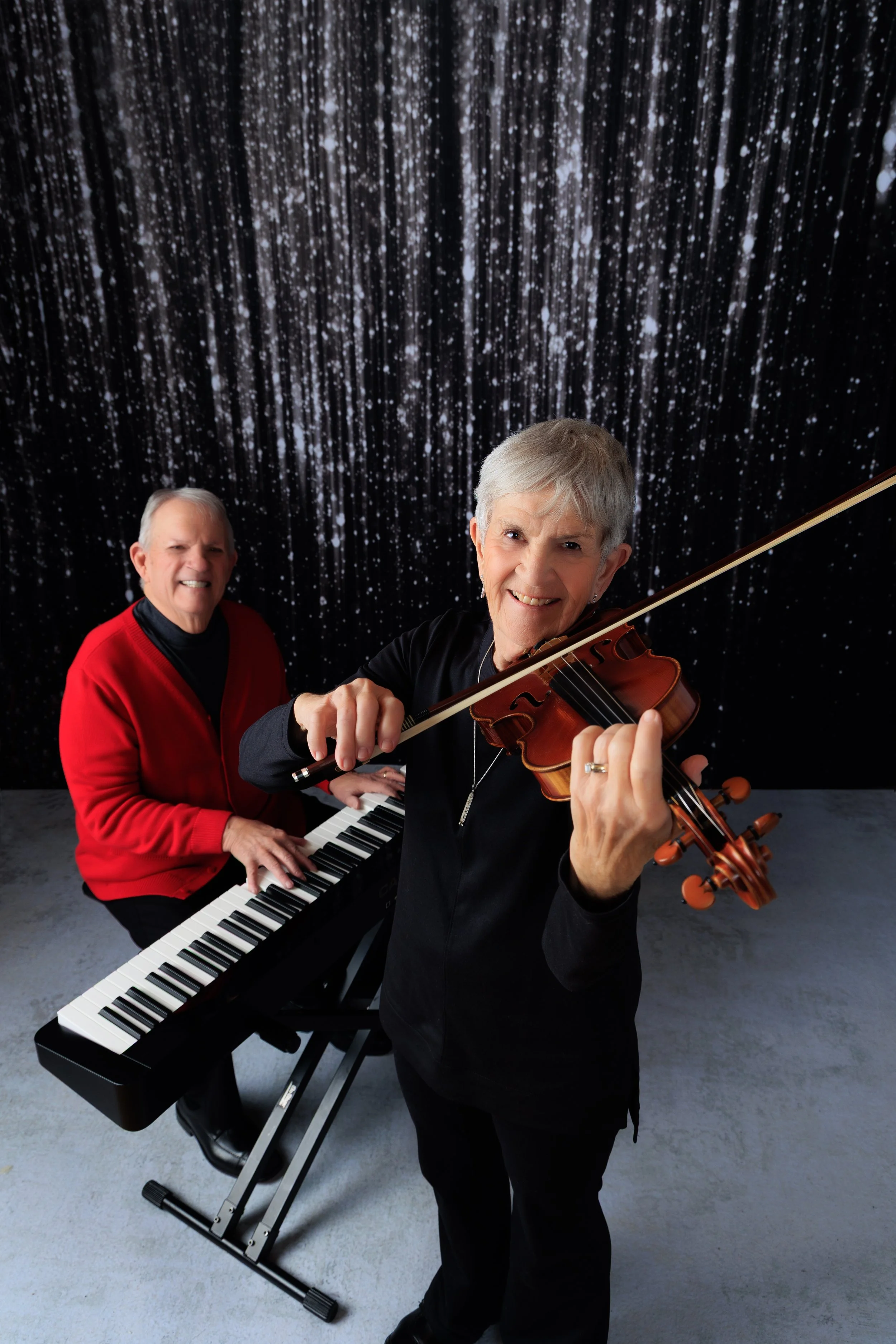 Lynn Basow playing violin with Bob Basow at the keyboard