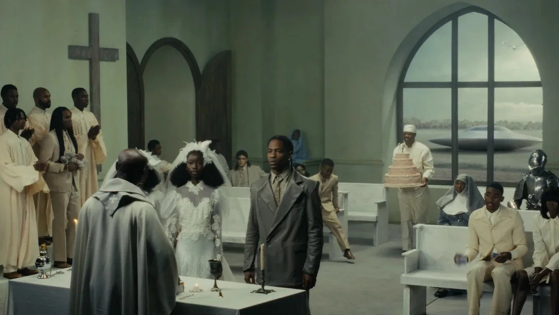 Travis Scott in the music video "Father" directed by Bianca Censori, church setting, Ye's Bully album, 2026.