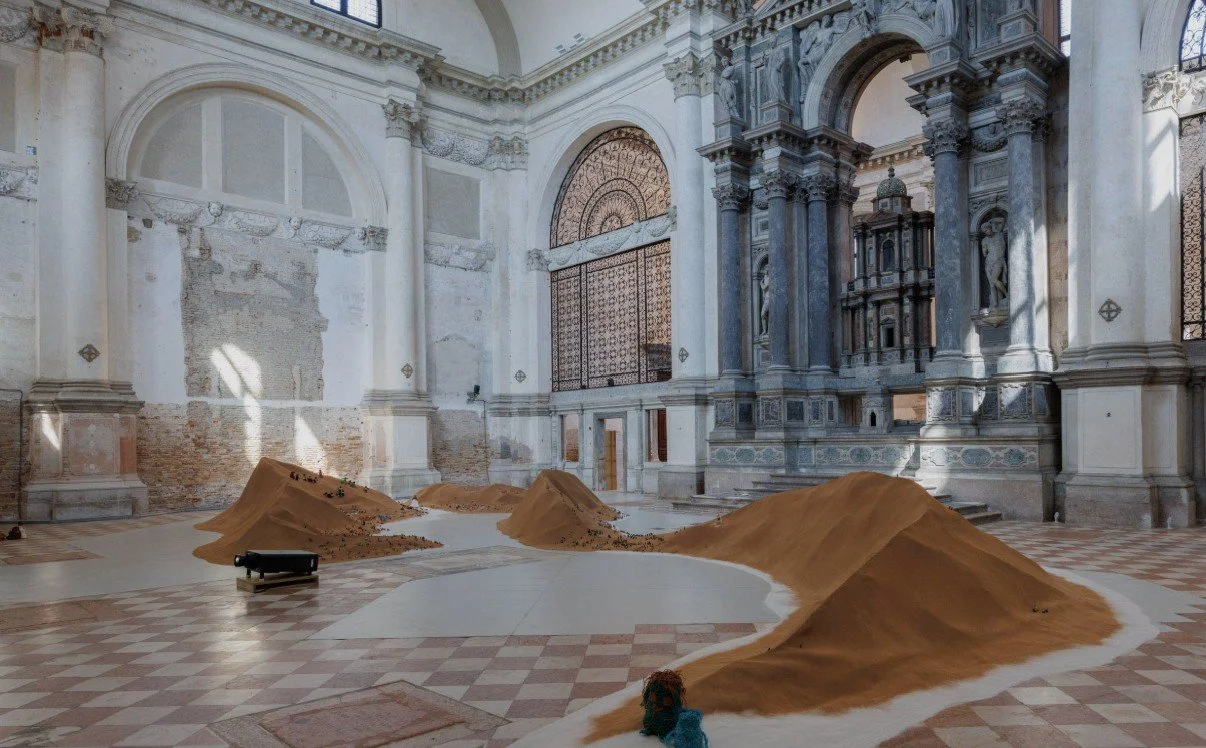 Repatriates Collective Tide of Returns installation at Ocean Space San Lorenzo Venice, mounds of sand and Dadikwakwa-kwa shell dolls, Venice Biennale 2026 collateral event.