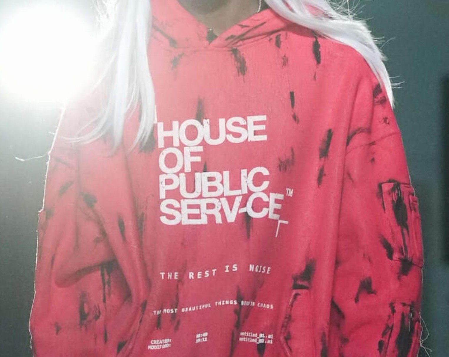 Model on the runway in Raphael Young's The Rest Is Noise SS27 collection for House of Public Serv-ce at New York Fashion Week modela wearing red sweatshirt with logo on it