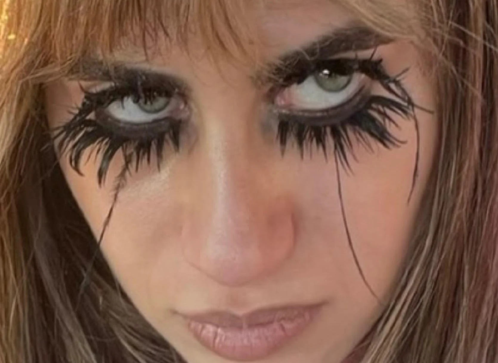 Singer CREAMS with dramatic eyelashes in Plastic Supernova video